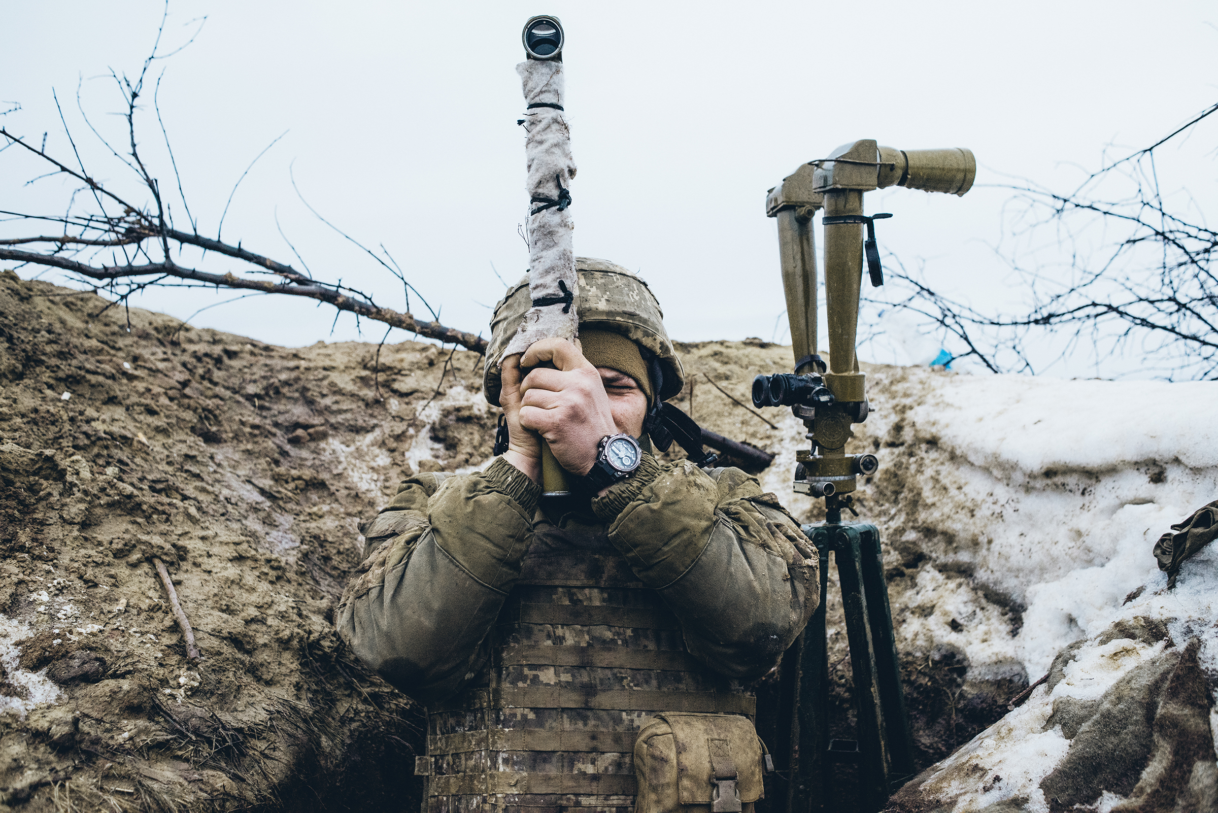 A Ukrainian soldier observes pro-Russian forces amassed on the front line in the breakaway Donetsk region of Ukraine on Feb. 8.