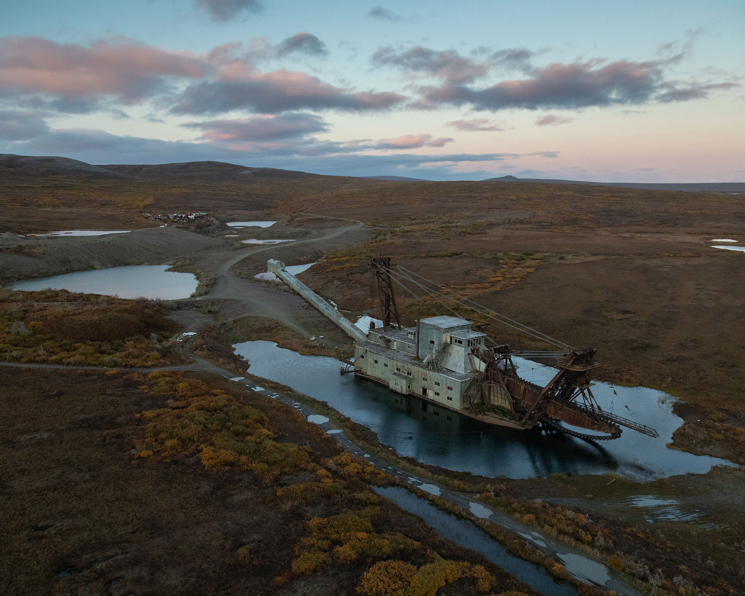 An abandoned gold dredger sits in the tundra behind Nome, <a href="https://time.com/6174947/melting-arctic-indigenous-communities-alaska/">Alaska</a>, on Sept. 19, 2021. The present-day city of Nome was established as a result of the gold rush that brought thousands of prospectors in the early 1900s. (Acacia Johnson for TIME)