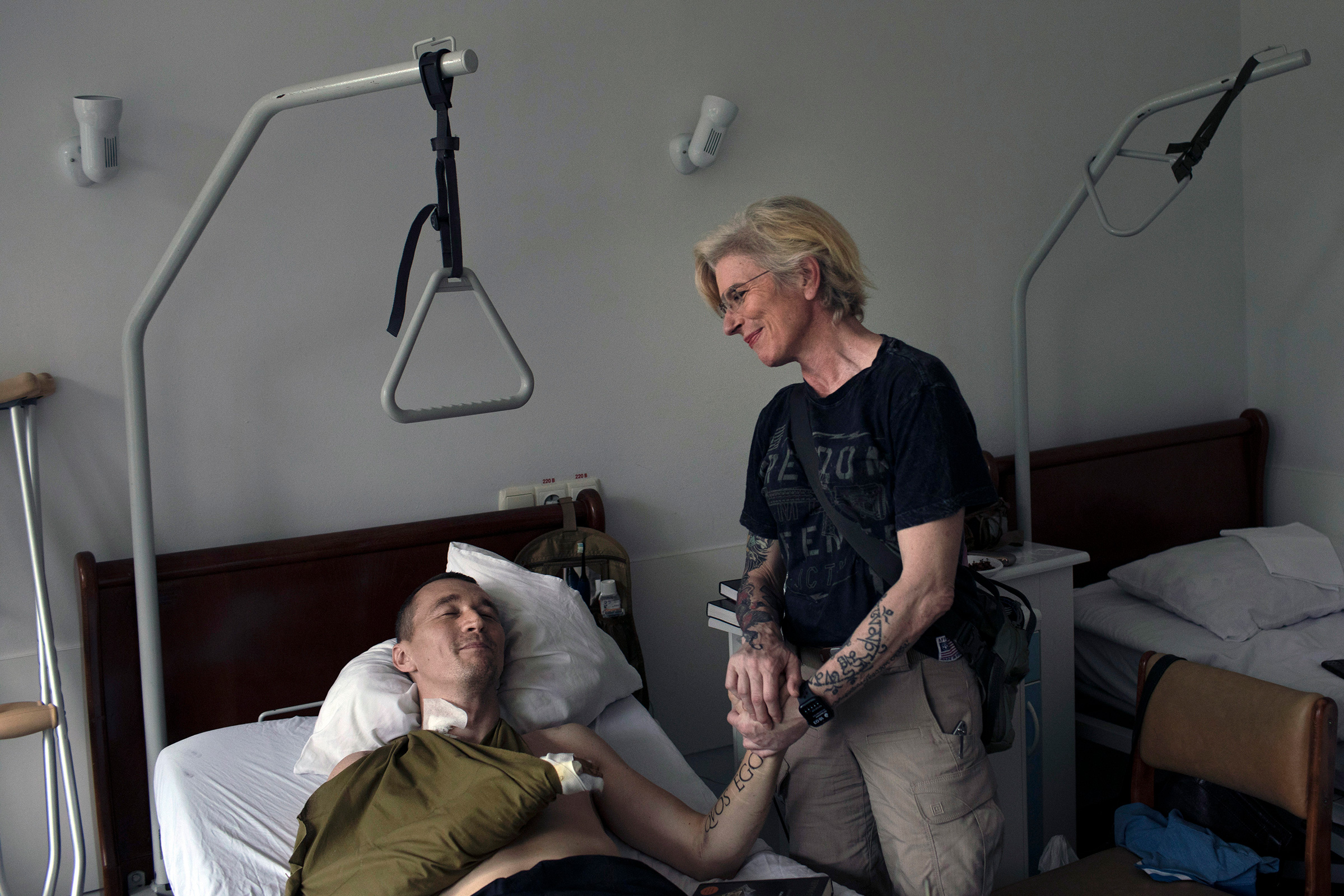 Julia Payevska, a medic who was imprisoned by Russian troops while working in Mariupol, visits her friend Yuriy Hudymenko, a wounded Ukrainian soldier, at the hospital in Kyiv where he has been recovering. (Emile Ducke—The New York Times/Redux)