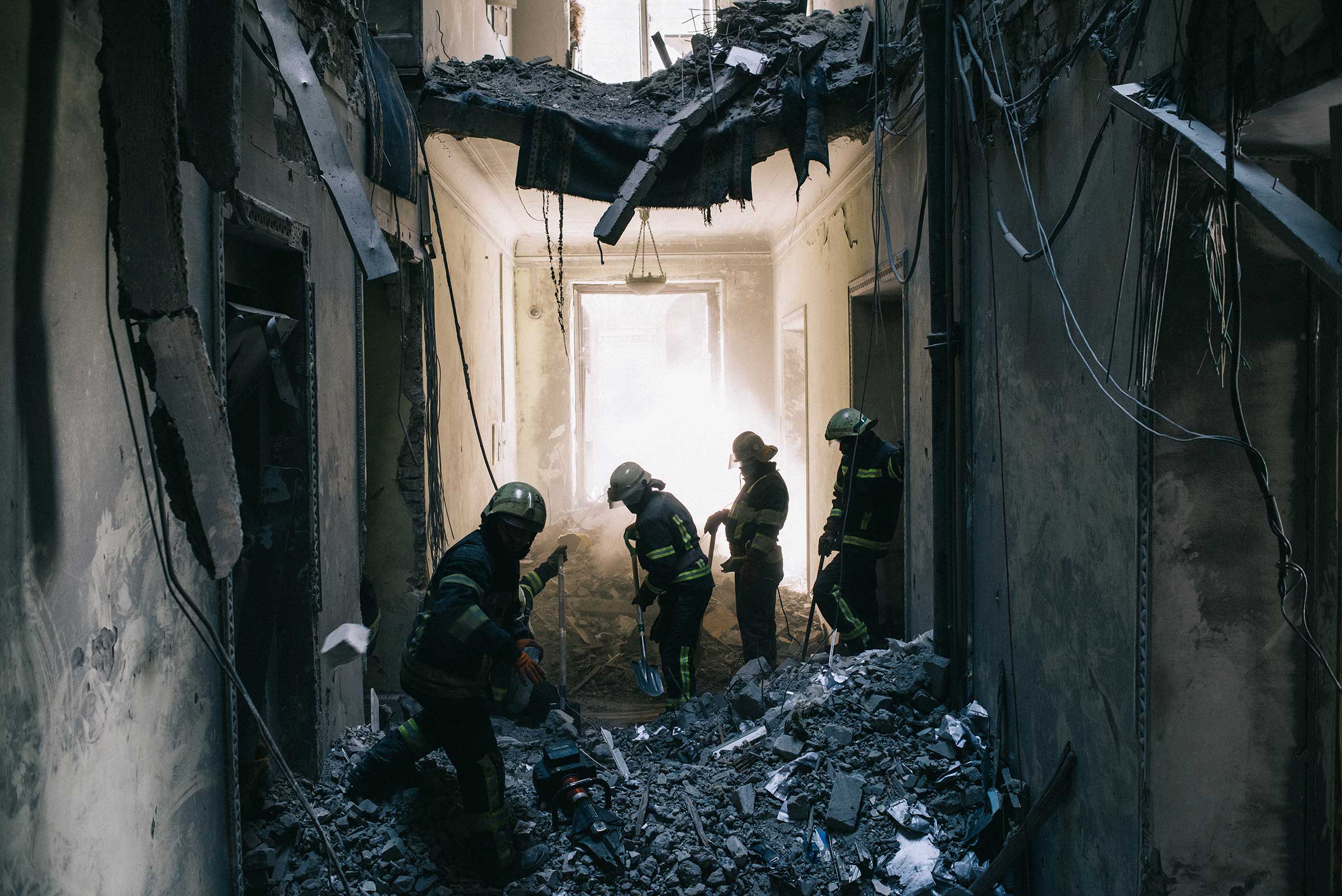 Firefighters clear debris from the Kharkiv Regional Council building which was damaged by an airstrike. (Maxim Dondyuk)