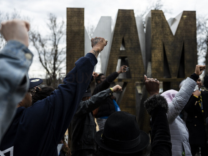 Protesters raise their fists as they march through the I AM A MAN Plaza in downtown Memphis, Tenn. on Saturday, Jan. 28, 2023, one day after the city of Memphis released video of several police officers beating Tyre Nichols. (Brad Vest/The New York Times)