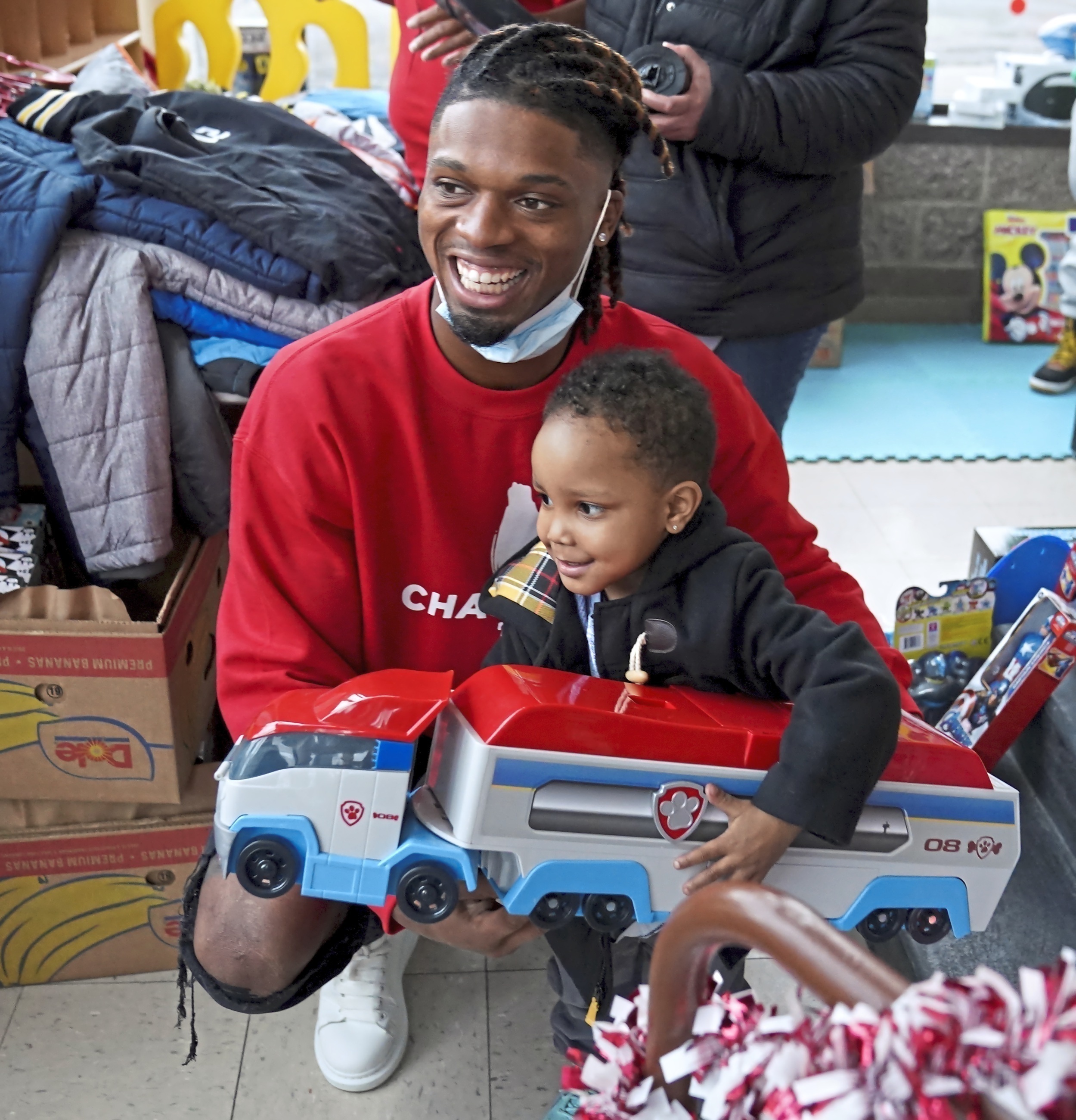 Then a college football defensive back in Pittsburgh, Damar Hamlin poses for a photo with Bryce Williams, 3, after the youngster picked out a toy during Hamlin's Chasing M's Foundation community toy drive at Kelly and Nina's Daycare Center in McKees Rocks, Pa., Dec. 22, 2020. (Matt Freed—Pittsburgh Post-Gazette/AP)