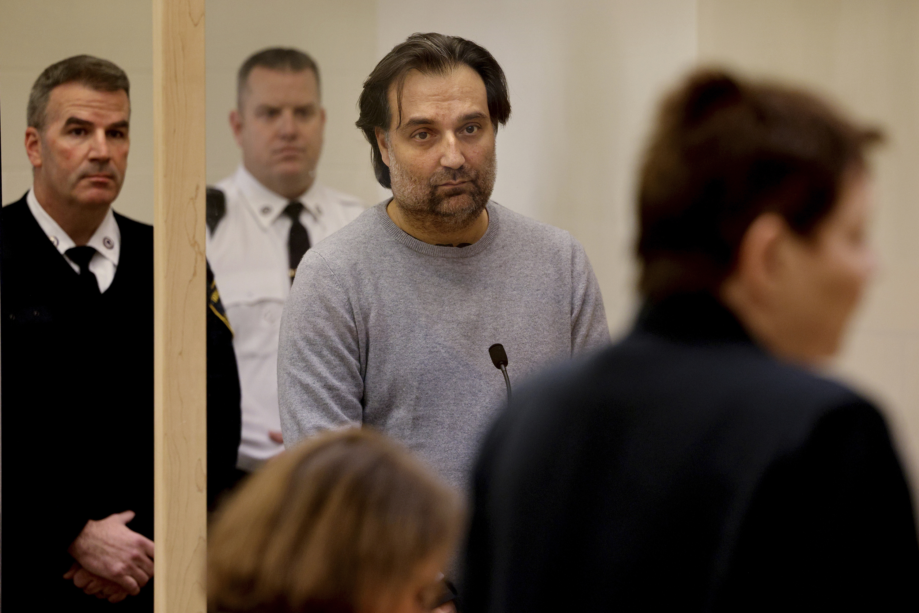 Brian Walshe, center, listens during his arraignment Wednesday, Jan. 18, 2023, at Quincy District Court, in Quincy, Mass., on a charge of murdering his wife Ana Walshe. Not guilty pleas were entered on behalf of Walshe, 47. Ana Walshe was reported missing Jan. 4, 2023 by her employer in Washington, where the couple has a home. (Craig F. Walker–The Boston Globe/AP/Pool)