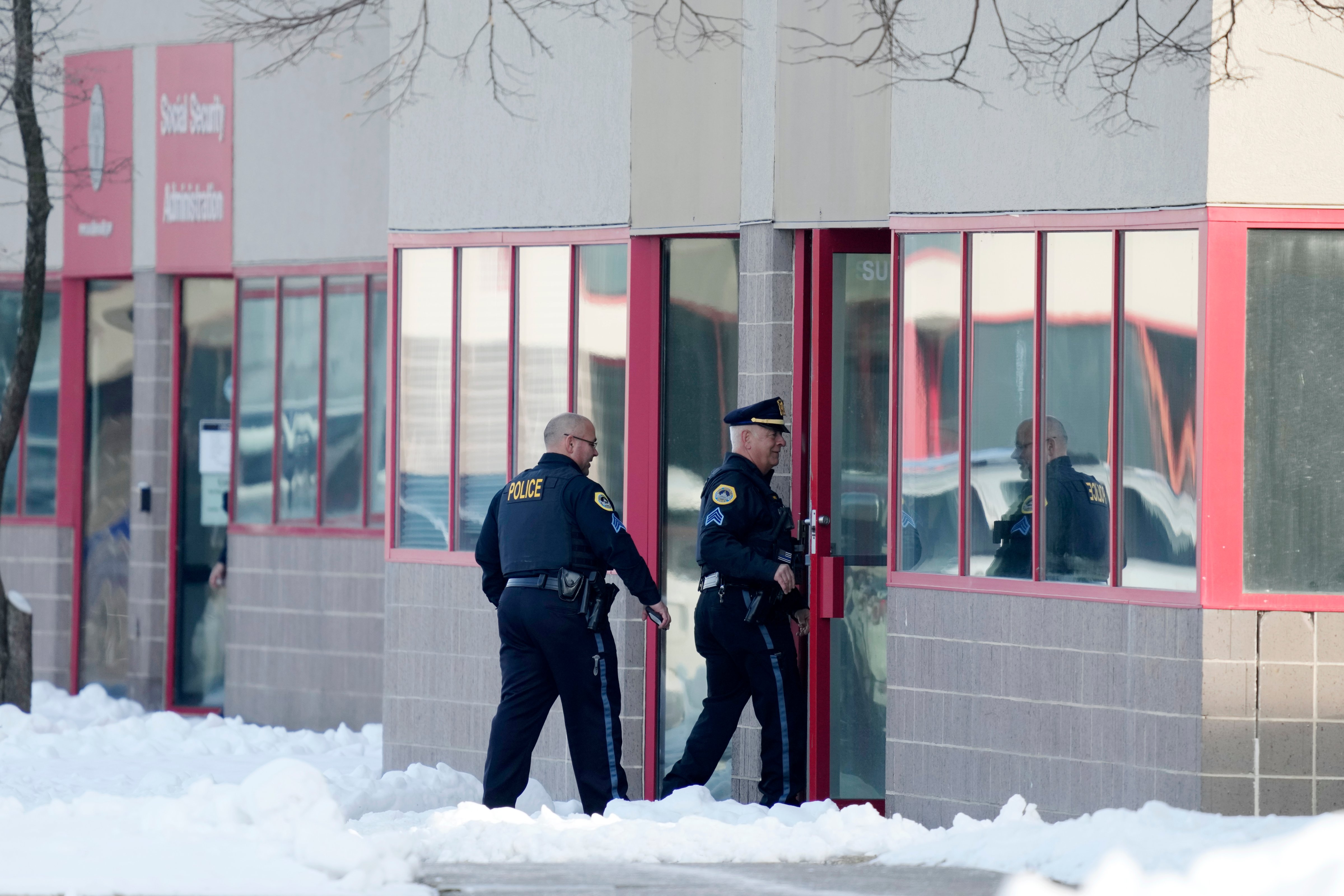 Law enforcement officers enter the Starts Right Here building, Monday, Jan. 23, 2023, in Des Moines, Iowa. Police say two students were killed and a teacher was injured in a shooting at the Des Moines school on the edge of the city's downtown. (Charlie Neibergall–AP)
