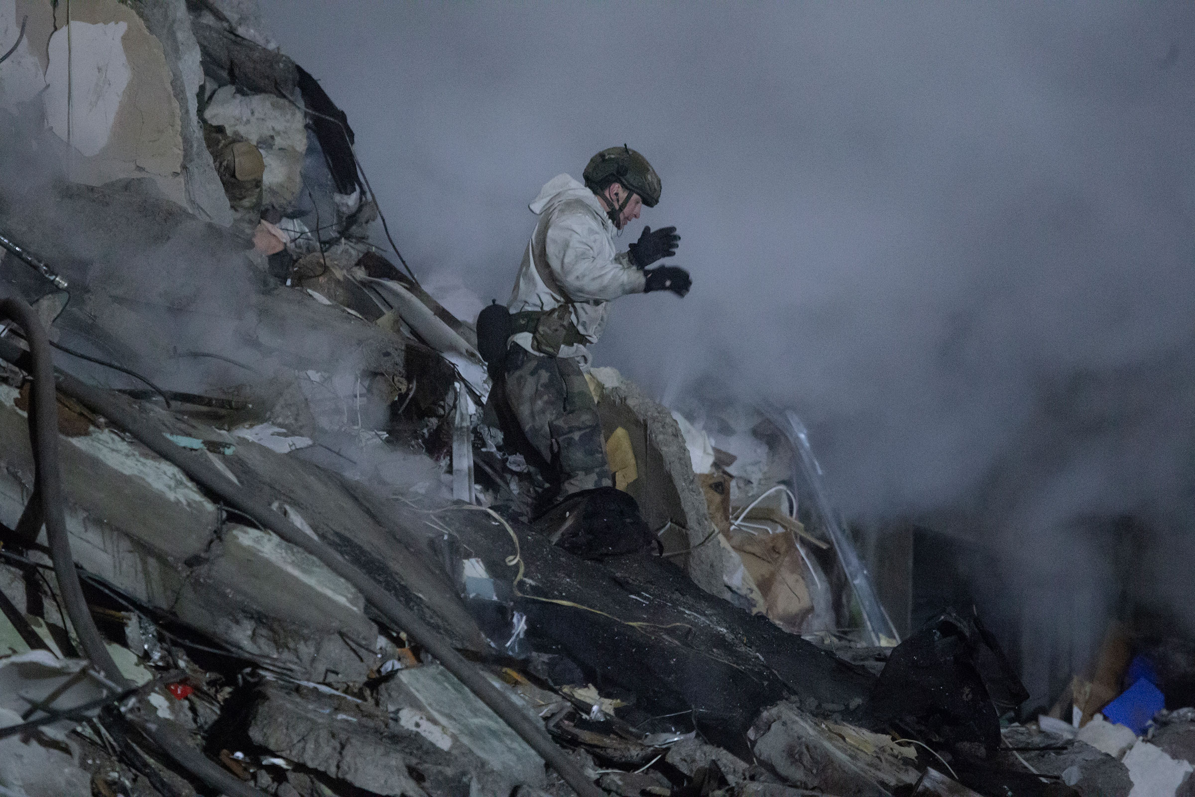 A rescue worker stands amid rubble during search and rescue operations in Dnipro, on Jan. 15. (Yan Dobronosov—Global Images Ukraine/Getty Images)