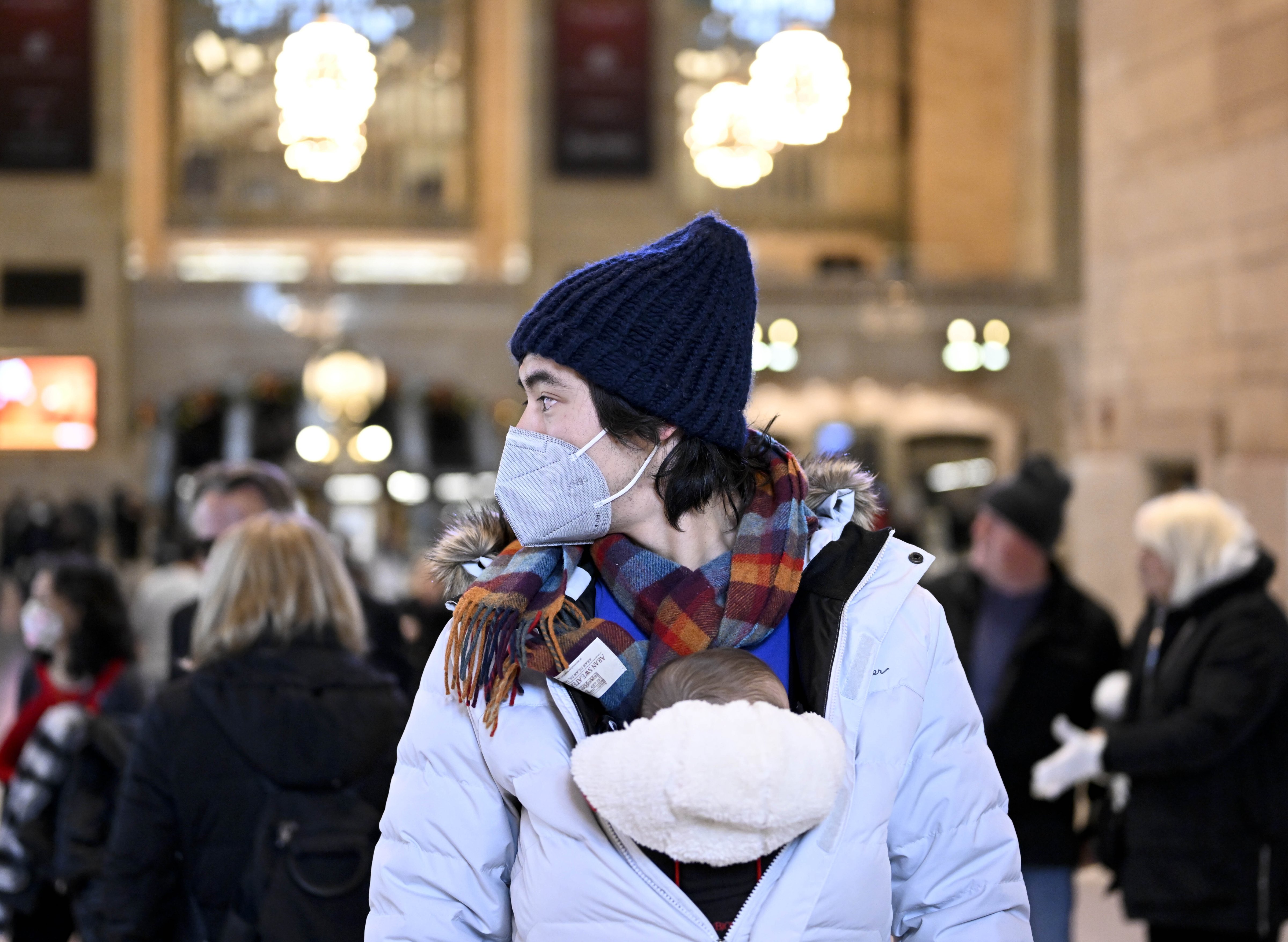 People wear masks after New York City's health officials issued an advisory, strongly urging New Yorkers to use masks as COVID-19, flu, and RSV cases rise, on December 12 in New York, United States. (Fatih Aktas/Anadolu Agency via Getty Images)
