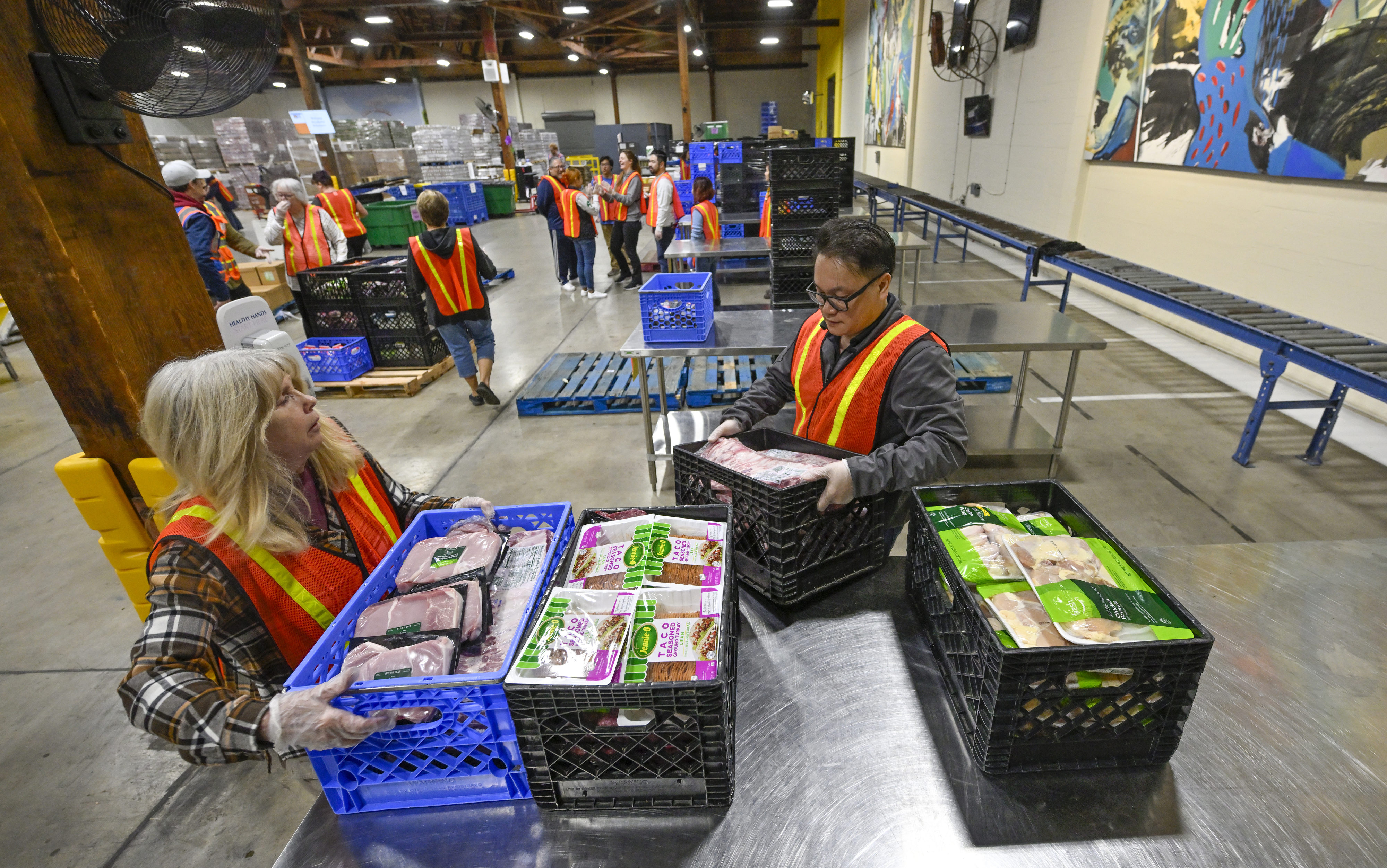 Volunteers sort through food donated by Amazon Fresh at a grocery rescue station inside Second Harvest Food Bank in Irvine, CA, on Thursday, December 1, 2022. (Jeff Gritchen––MediaNews Group/Orange County Register via Getty Images)