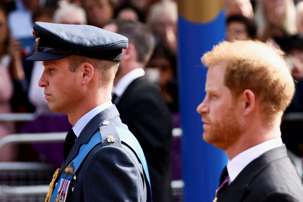 Prince William, left, and Prince Harry, right, walk behind the coffin of Queen Elizabeth II during a procession from Buckingham Palace to the Palace of Westminster in London, England, on Sep. 14, 2022. (Henry Nicholls—Pool/Getty Images)