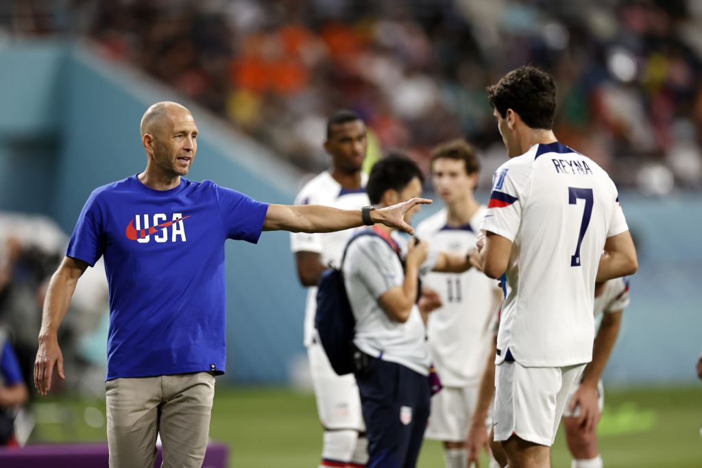 United States men's soccer coach Gregg Berhalter addresses substitute player Giovanni Reyna during the FIFA World Cup match against the Netherlands in Qatar on Dec. 3, 2022. (Maurice Van Stone—ANP/Getty Images)