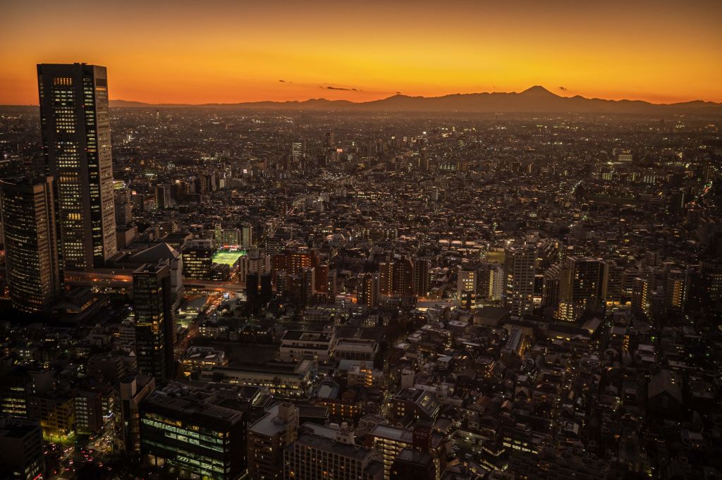 Mount Fuji is seen behind the city skyline at dusk from Tokyo Metropolitan Government Building Observatories on Dec. 15, 2022. (Yuichi Yamazaki—AFP/Getty Images)