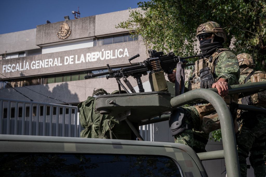 Army members stand guard outside the Attorney General's Office for Special Investigations on Organized Crime (FEMDO) in Mexico City, Jan. 5, 2023, after the arrest of the son, Ovidio, of imprisoned drug trafficker Joaquin "El Chapo" Guzman. (Nicolas Asfouri—AFP/Getty Images)