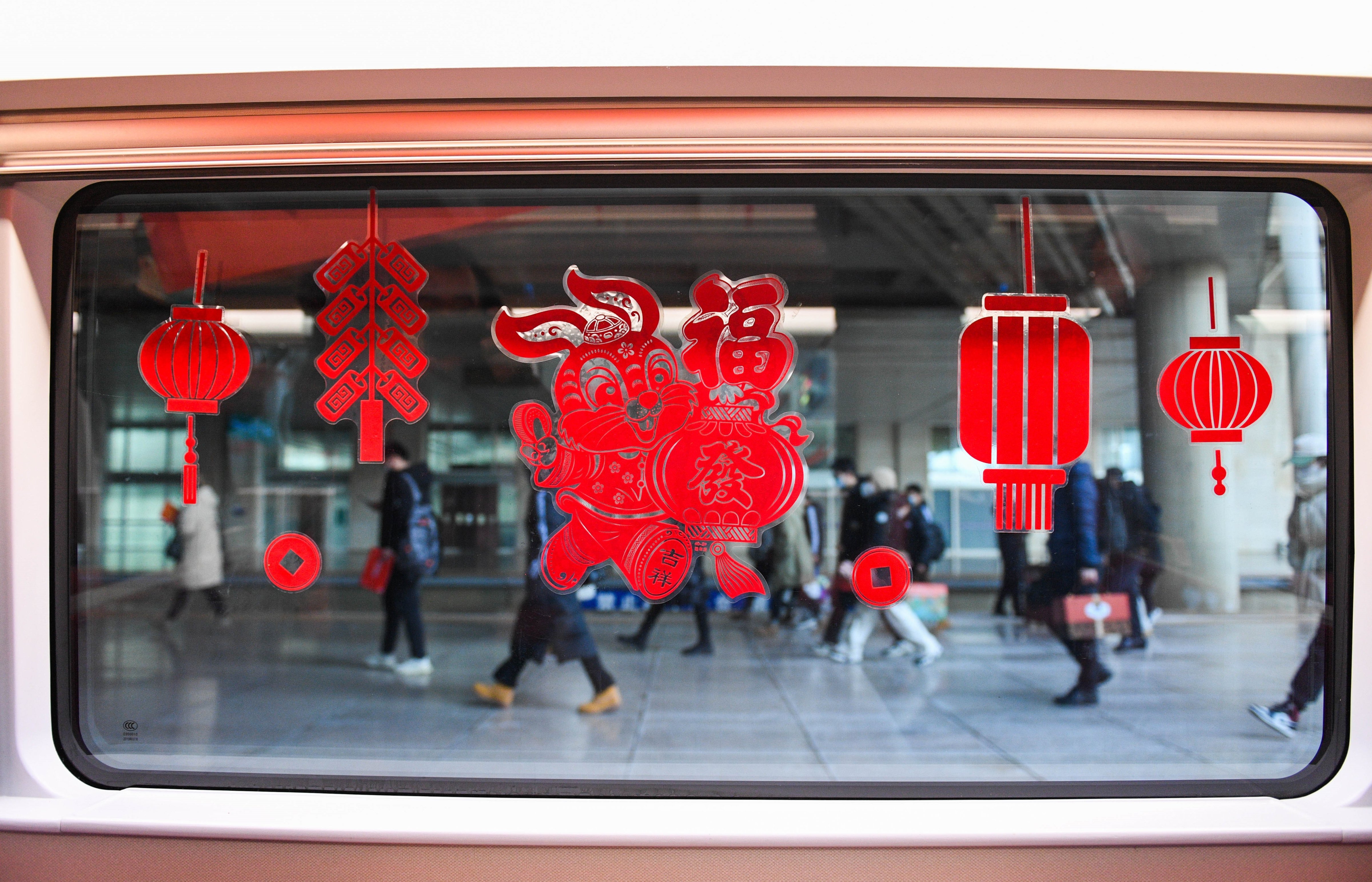 Decorations adorn the Fuxing bullet train G2457, which travels from Beijing to Hohhot, at Hohhot East Railway Station in Hohhot, Jan. 14, 2023. (Liu Lei—Xinhua/Getty Images)