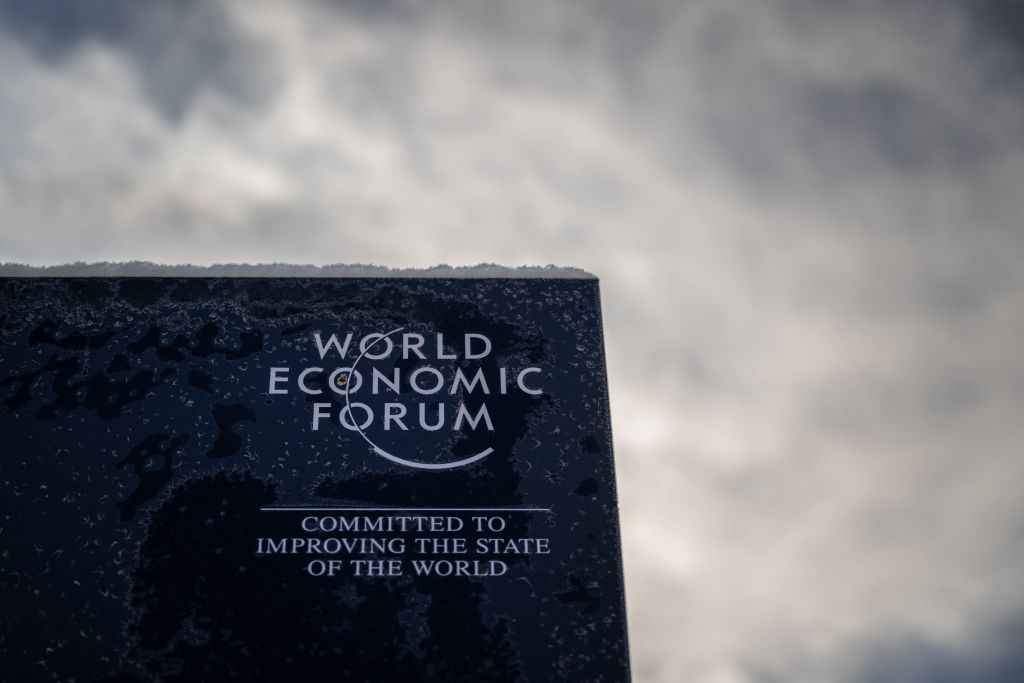 A photograph shows a sign of the World Economic Forum (WEF) in the alpine resort of Davos, on the opening day of the annual meeting in Davos on Jan. 16, 2023. (Fabrice Coffrini—AFP via Getty Images)