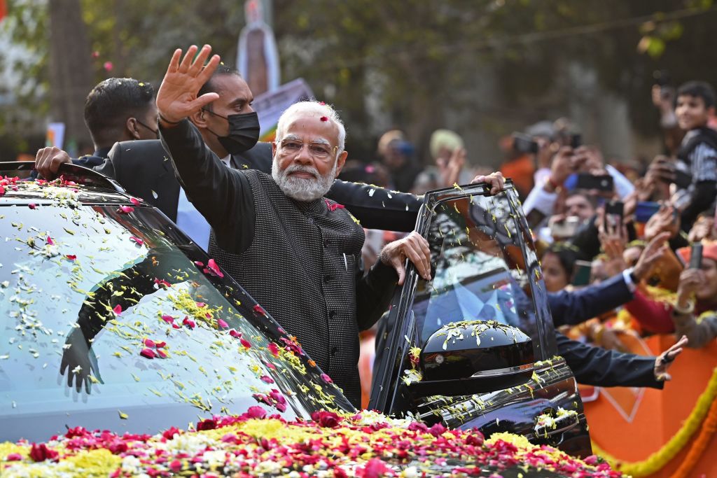 India's Prime Minister Narendra Modi (C) waves to his supporters during a roadshow ahead of the BJP national executive meet in New Delhi on January 16, 2023. (Sajjad HUSSAIN-AFP)