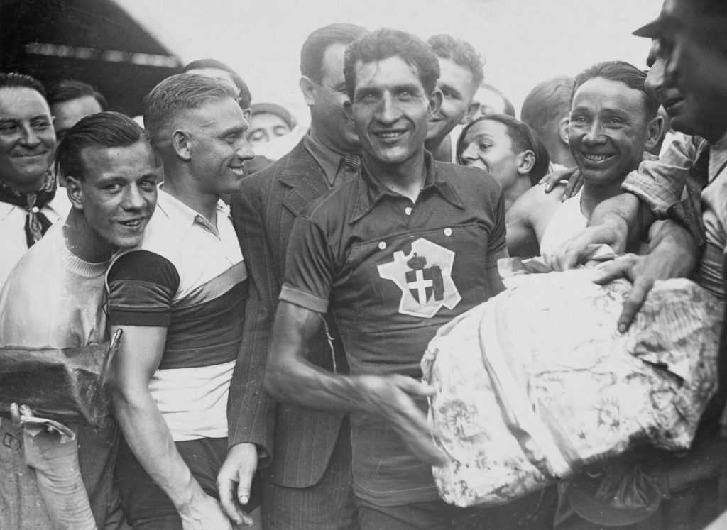 Italian champion road cyclist Gino Bartali (1914 - 2000) celebrates his victory of the Tour De France, France, July 1938. (FPG/Archive Photos/Getty Images)