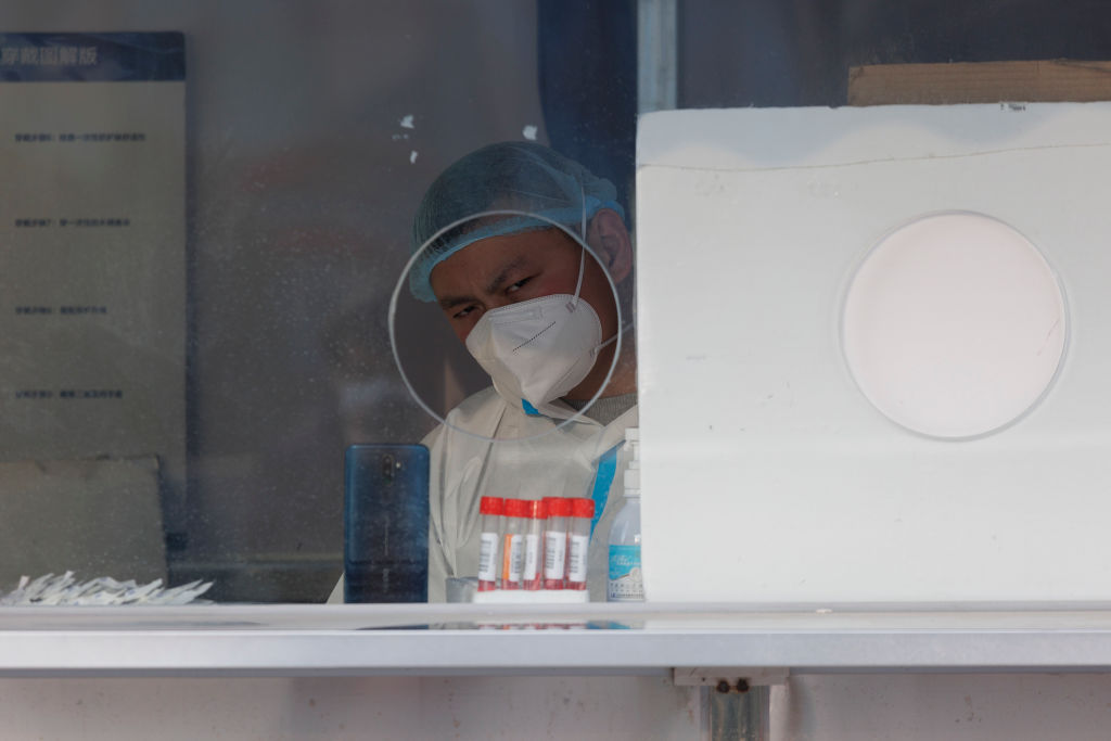 A health worker wearing protective gear in a COVID-19 testing station in Shanghai, China, on Jan. 04, 2023. (Hugo Hu—Getty Images)