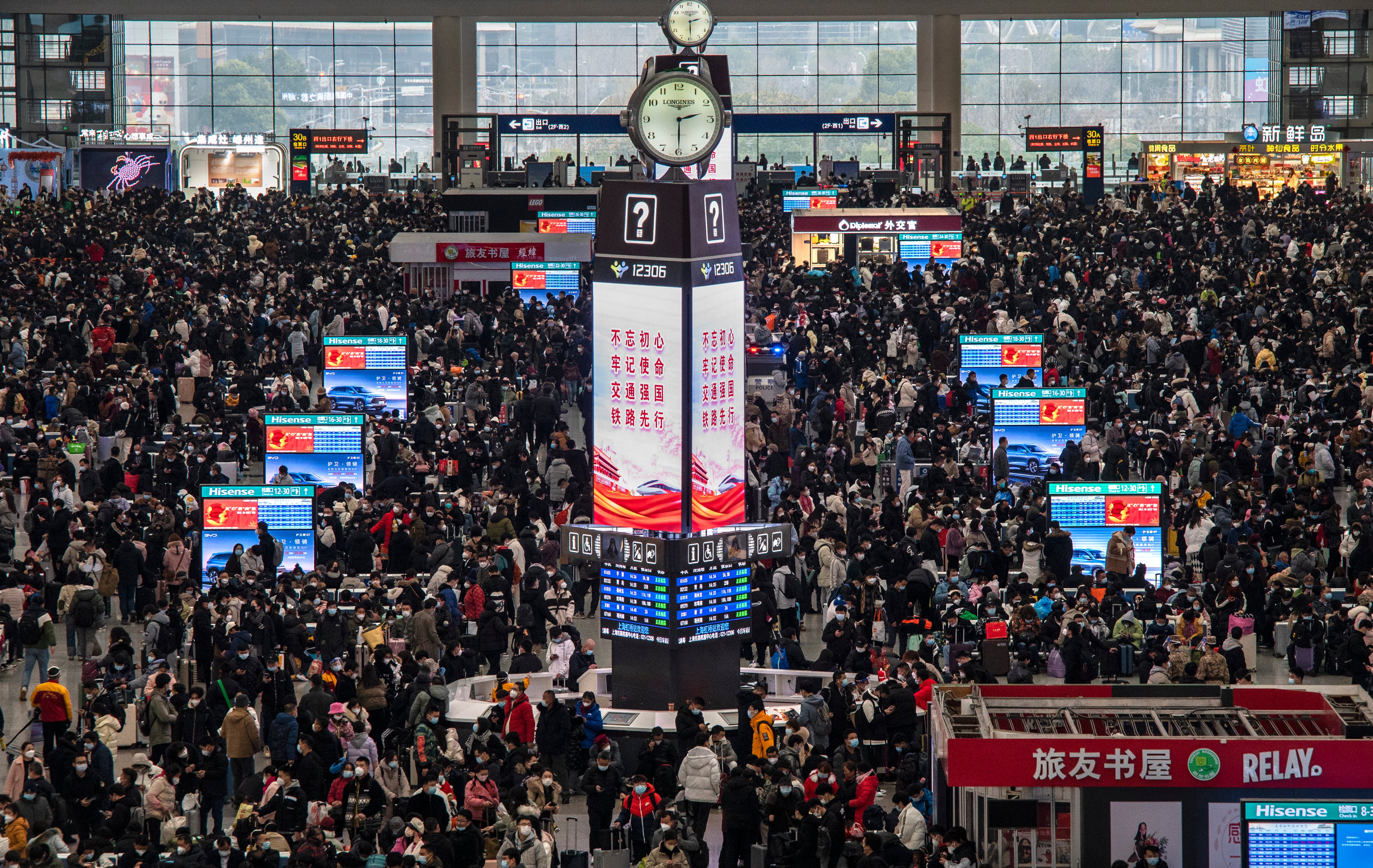 Travelers crowd at the gates and wait for trains at the Shanghai Hongqiao Railway Station during the peak travel rush for the upcoming Chinese New Year holiday, Jan. 15, 2023. (Kevin Frayer—Getty Images)