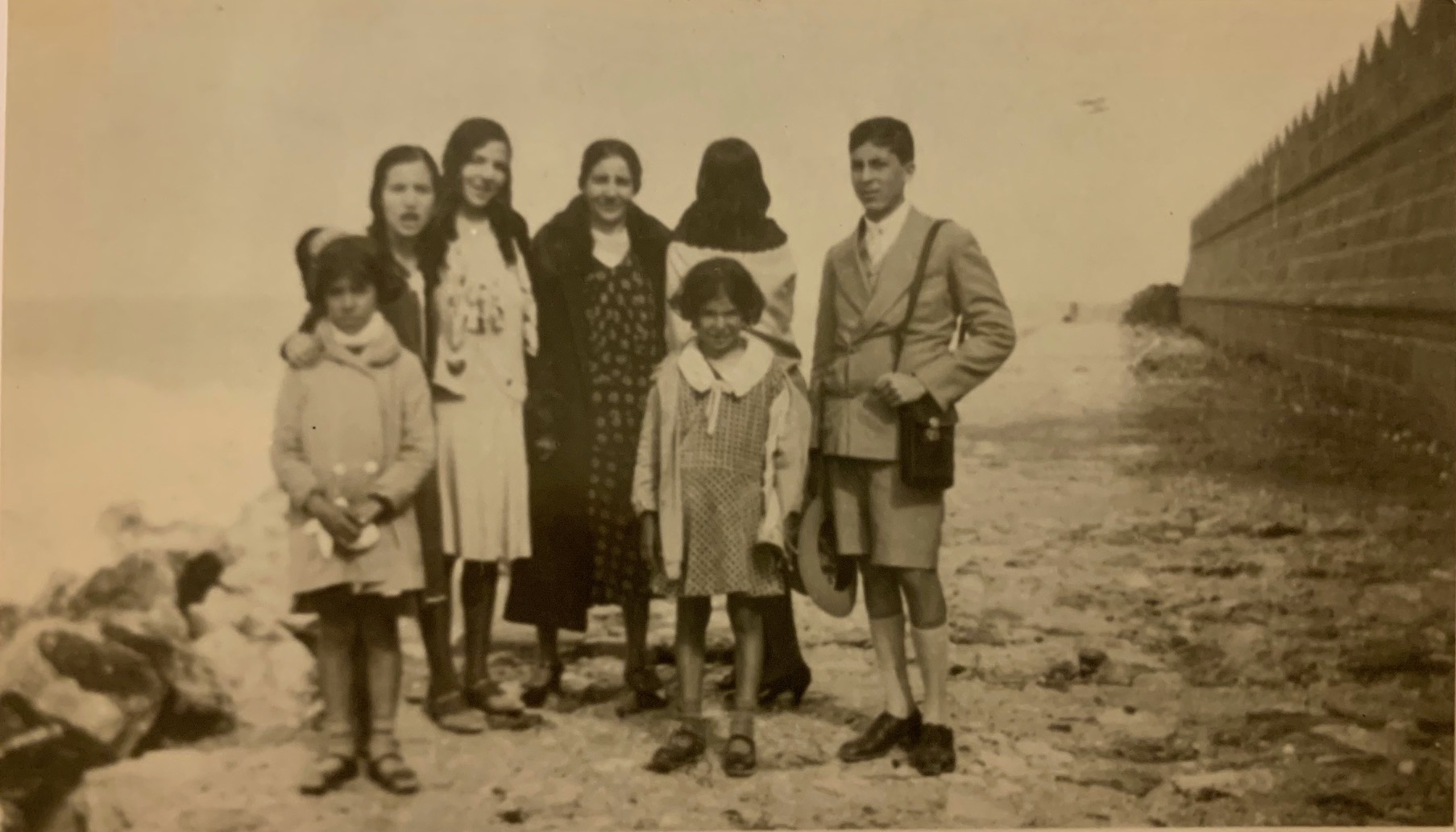 Stella Levi (front right, with her coat open) photographed with family and friends outside the city walls of Rhodes, c. 1928. (Courtesy of Stella Levi)