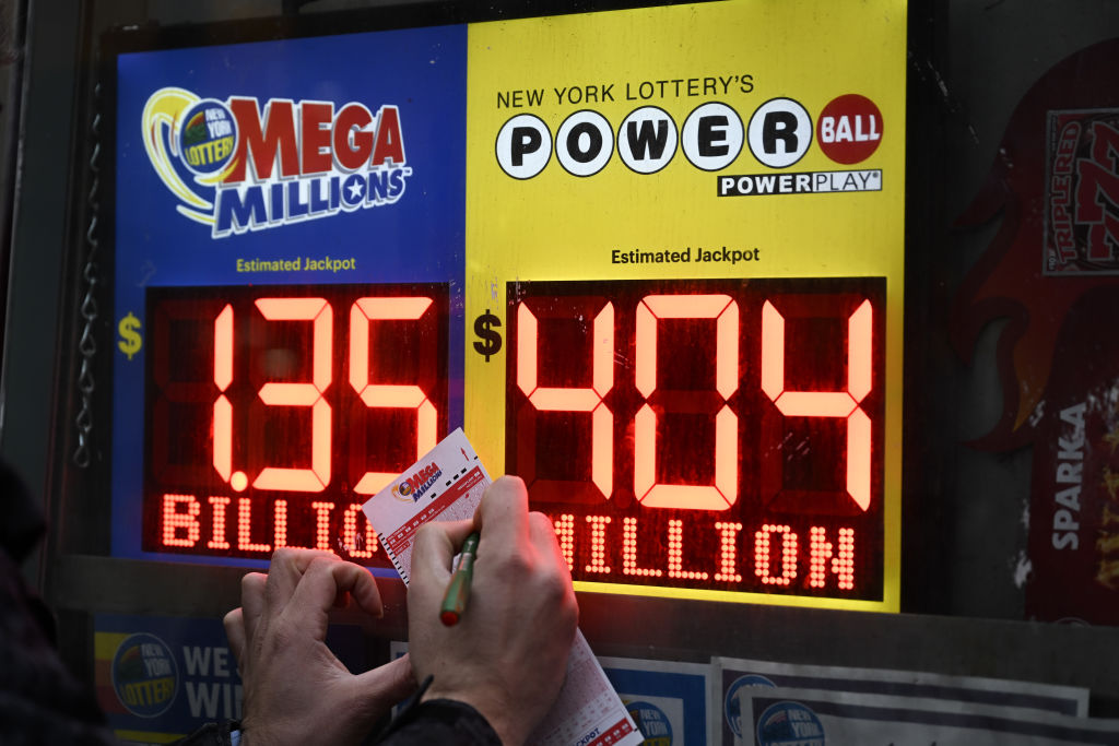 Mega Millions sign and lottery tickets are seen at a store in New York, NY, on January 12, 2023. (Fatih Aktas—Anadolu Agency/Getty Images)