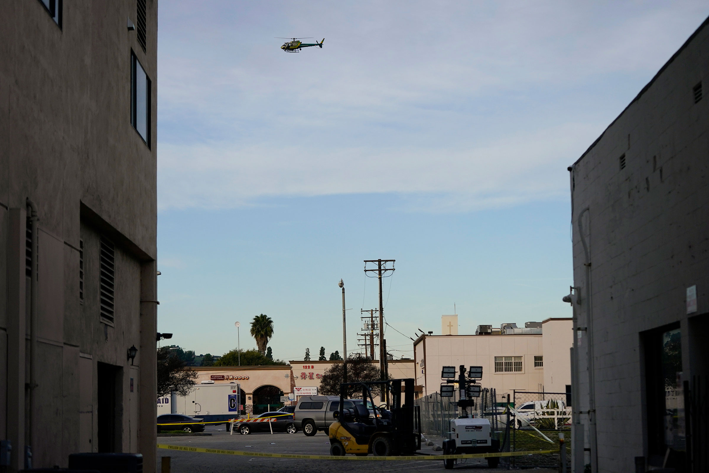 A law enforcement helicopter hovers over Star Dance Studio in Monterey Park, Calif., on Jan. 22, 2023. (Jae C. Hong—AP)