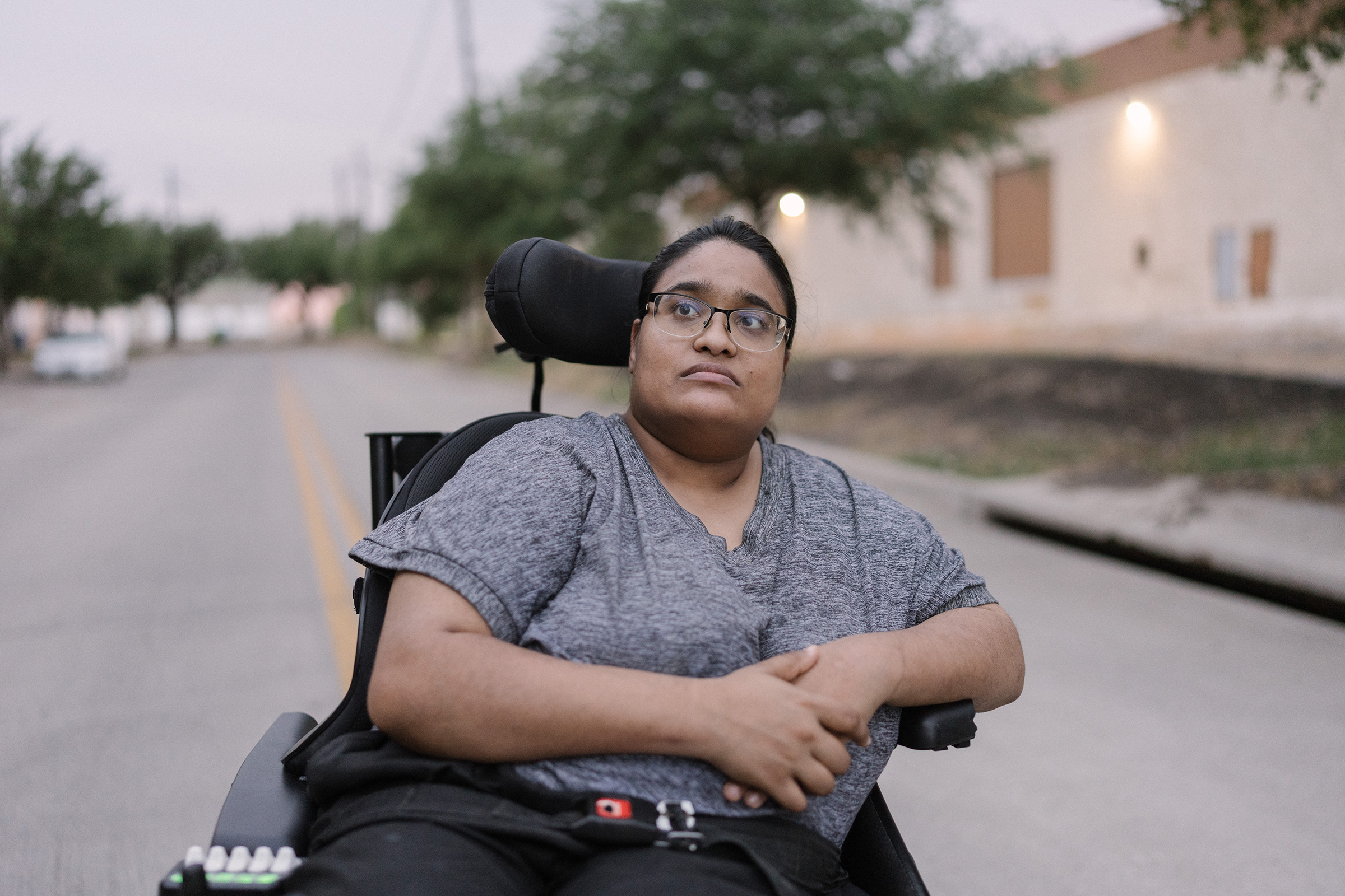 Joy Moonan next to her apartment building in Dallas on July 20, 2022. Moonan, an attorney and disability-rights advocate, uses a wheelchair due to her cerebral palsy. (Morgan Lieberman)