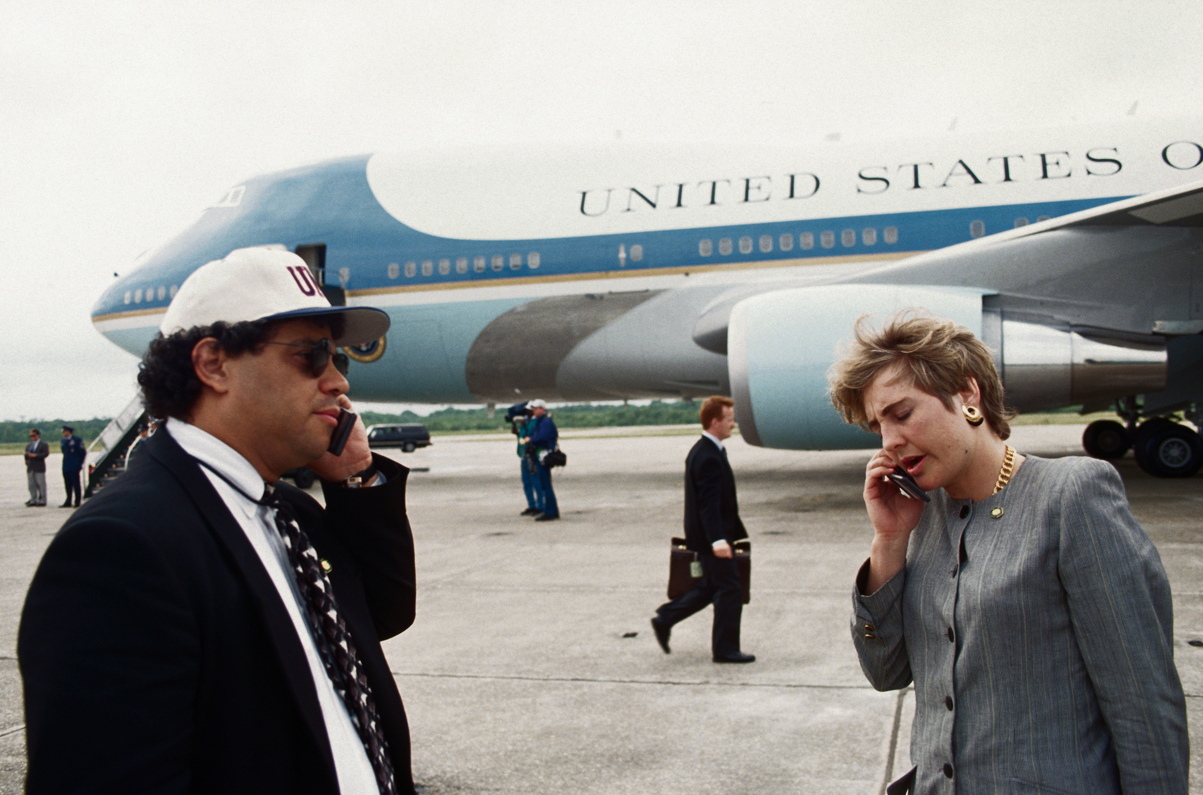 Presidential advisers Steve Rabinowitz and Dee Dee Myers talk on cell phones on the tarmac next to Air Force One, on April 30, 1993. (Wally McNamee—CORBIS/Getty Images)