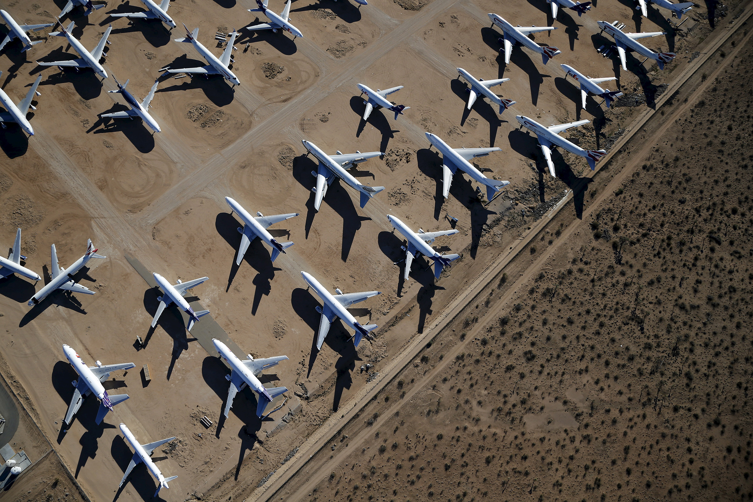 Old airplanes, including Boeing 747-400s, are stored in the desert in Victorville, California March 13, 2015. In the last year, there were zero orders placed by commercial airlines for new Boeing 747s or Airbus A380s, reflecting a fundamental shift in the industry toward smaller, twin-engine planes. (Lucy Nicholson—Reuters)