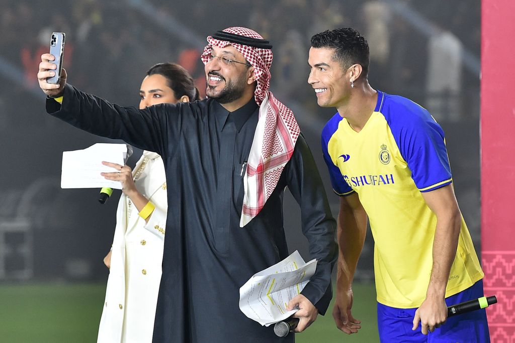 Al-Nassr's new Portuguese forward Cristiano Ronaldo poses for a selfie with the presenters during his unveiling at the Mrsool Park Stadium in Riyadh, Saudi Arabia on Jan. 3, 2023. (AFP/Getty Images)