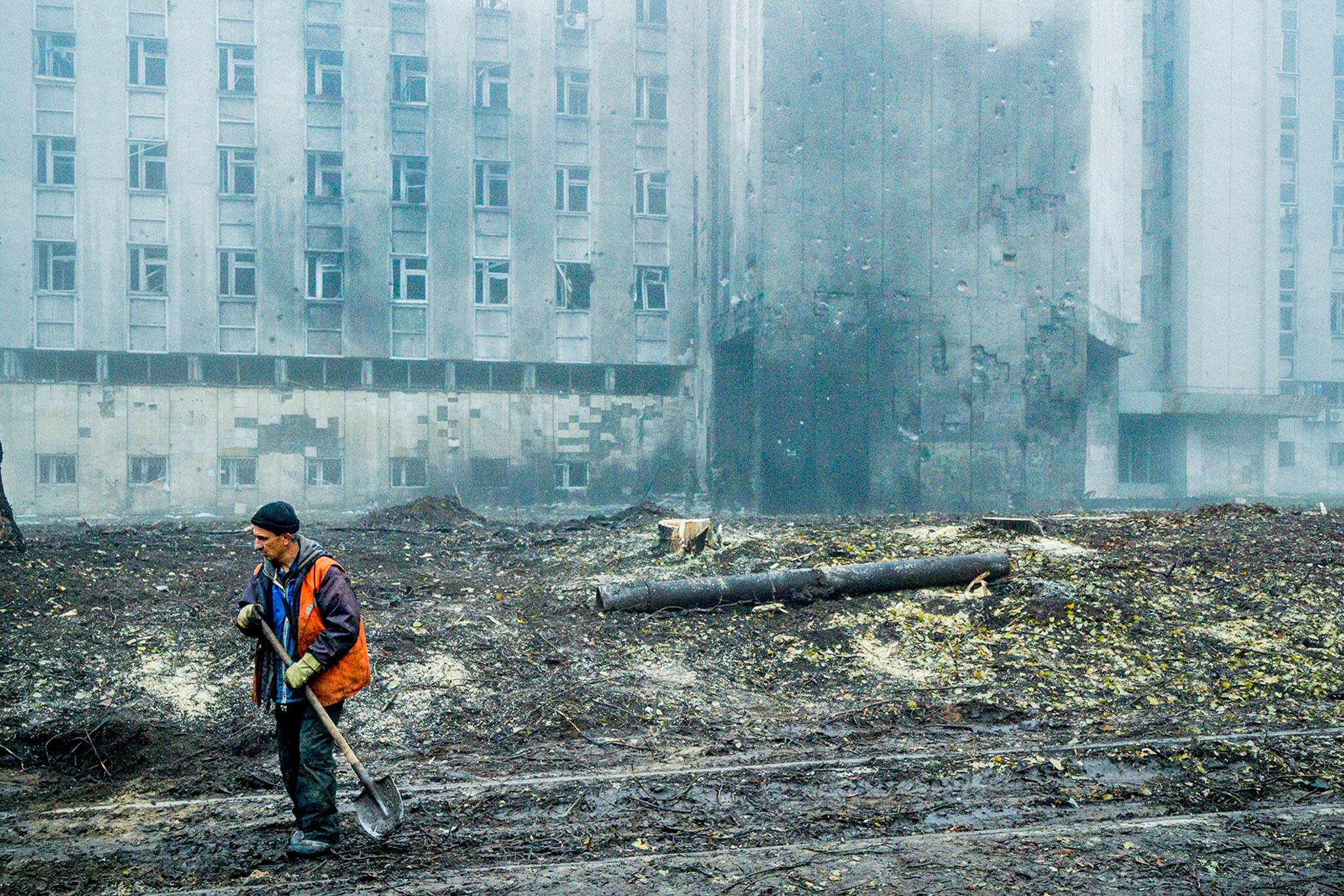 A worker cleans the debris in the streets of Dnipro on Nov. 17, 2022 after a Russian missile impacted in the city. (Celestino Arce—NurPhoto/Getty Images)