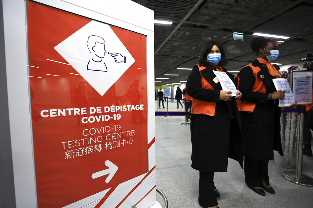 Airport staff wait from passengers coming from China in front of a COVID-19 testing area set at the Roissy Charles de Gaulle airport, north of Paris, Sunday, Jan. 1, 2023. (Aurelien Morissard—AP)