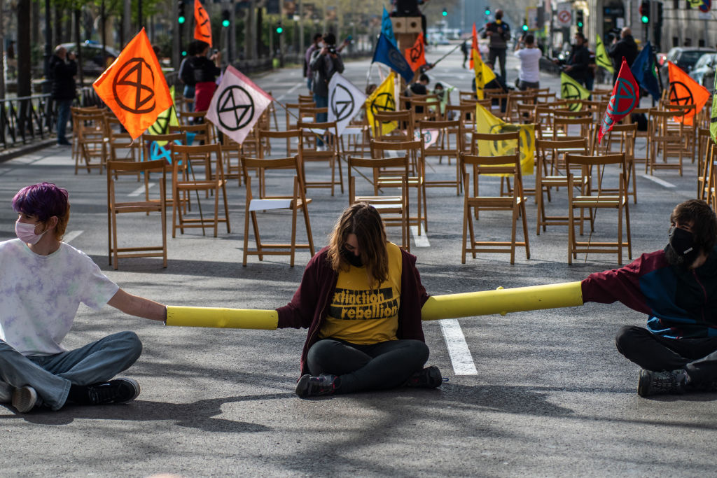 Climate change activists of Extinction Rebellion (XR) group chained themselves blocking the street in front of the Health Ministry in Madrid, Spain, on Feb. 26, 2021. (Marcos del Mazo/LightRocket— Getty Images)