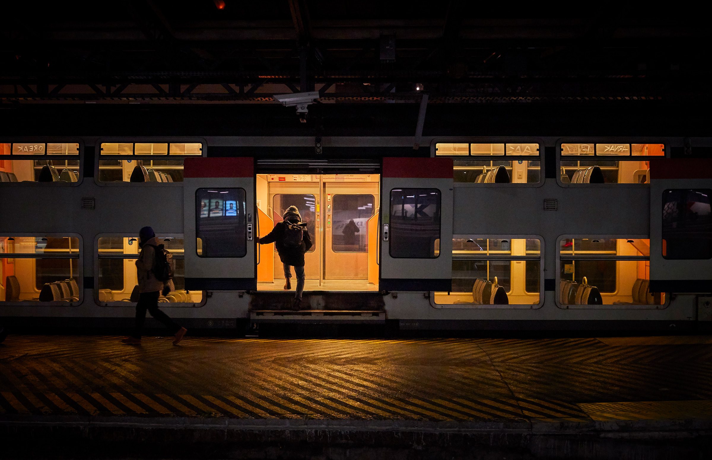 A passenger boards a suburban train at Gare de l'Est Railway Station in Paris as France is hit by widespread traffic disruption with limited services running as transport workers join a nationwide strike on Jan. 19. (Kiran Ridley—Getty Images)