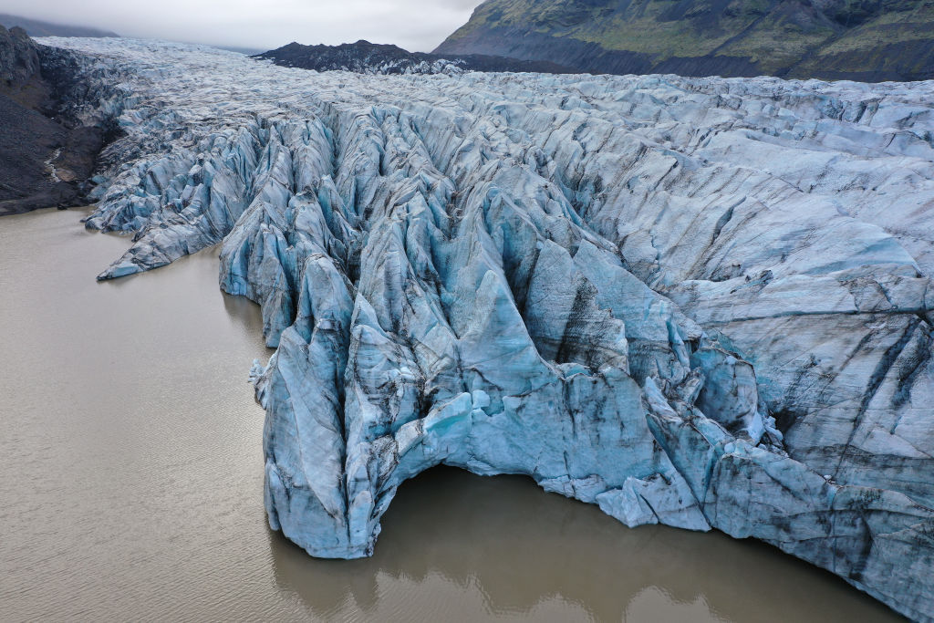 In this aerial view Svinafellsjokull glacier ends at a small lake on August 13, 2021 near Svinafell, Iceland. Iceland is feeling a strong impact from global warming. (Sean Gallup—Getty Images)