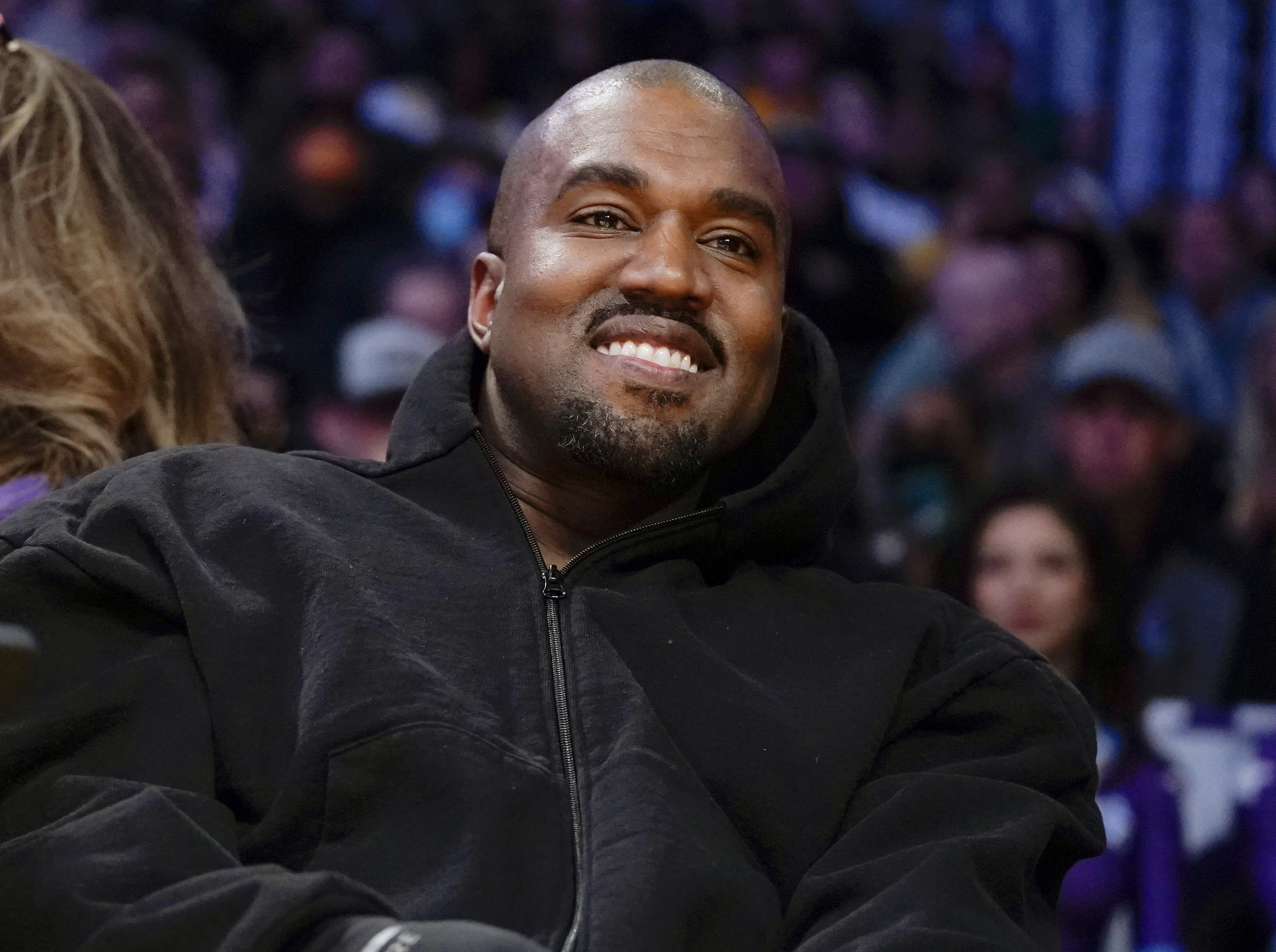 Kanye West, known as Ye, watches the first half of an NBA basketball game between the Washington Wizards and the Los Angeles Lakers in Los Angeles, on March 11, 2022. A senior Australian government minister said Wednesday, Jan. 25, 2023, that Ye, could be refused a visa due to antisemitic comments if he attempts to visit Australia. (Ashley Landis–AP)