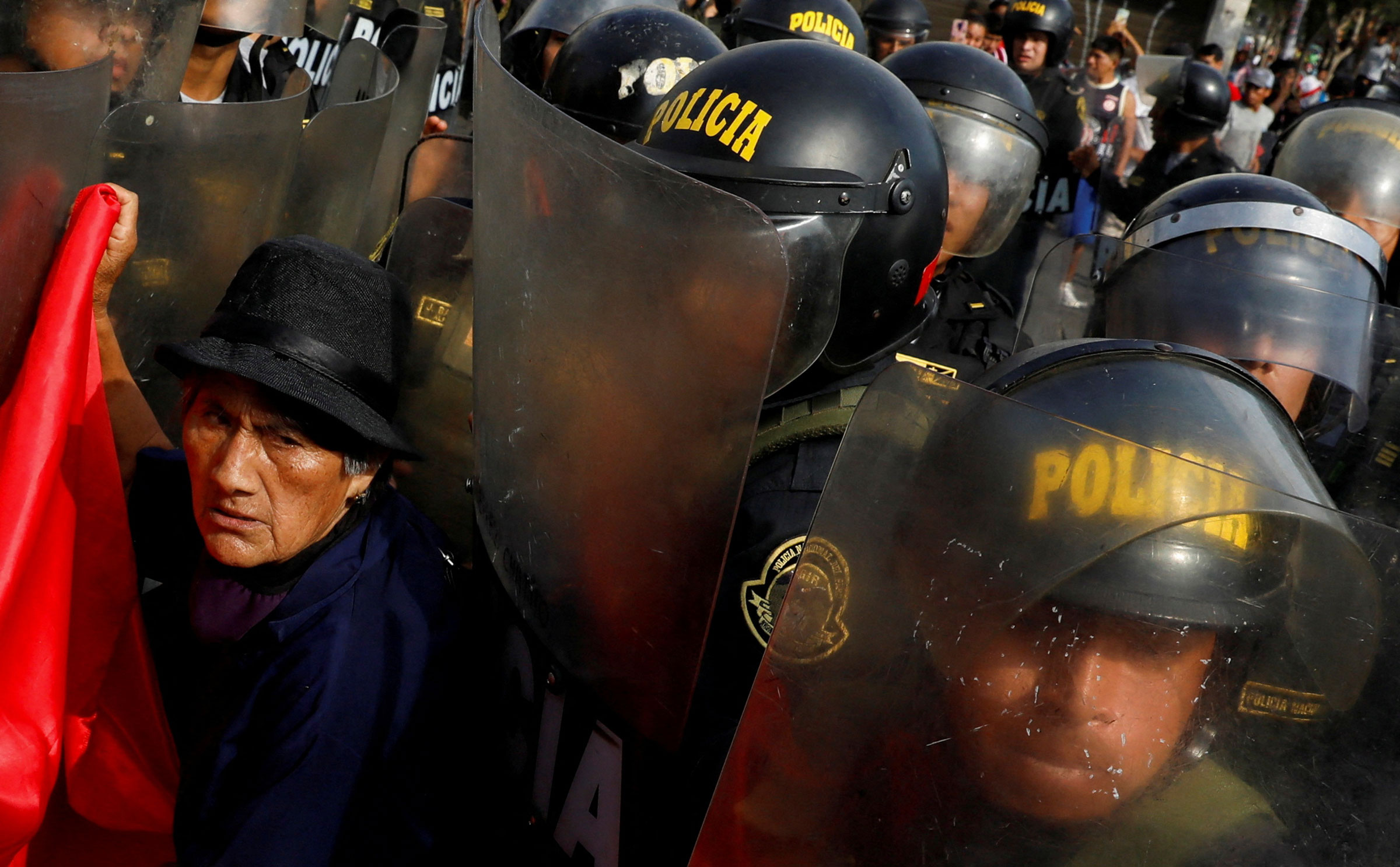 A protester interacts with police during the ‘Take over Lima’ march to demonstrate against Peru’s President Dina Boluarte, following the ousting and arrest of former President Pedro Castillo