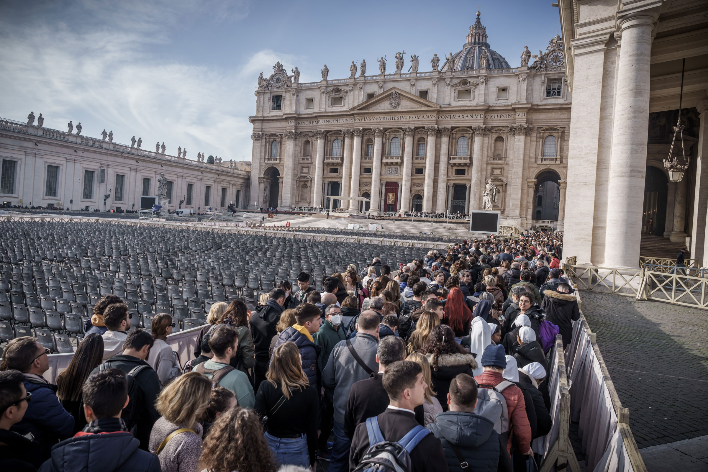 Faithful stand in St. Peter’s Square to bid farewell to the body of the late Pope Emeritus Benedict XVI, who is laid out in public in St. Peter’s Basilica, on Jan. 4, 2023.