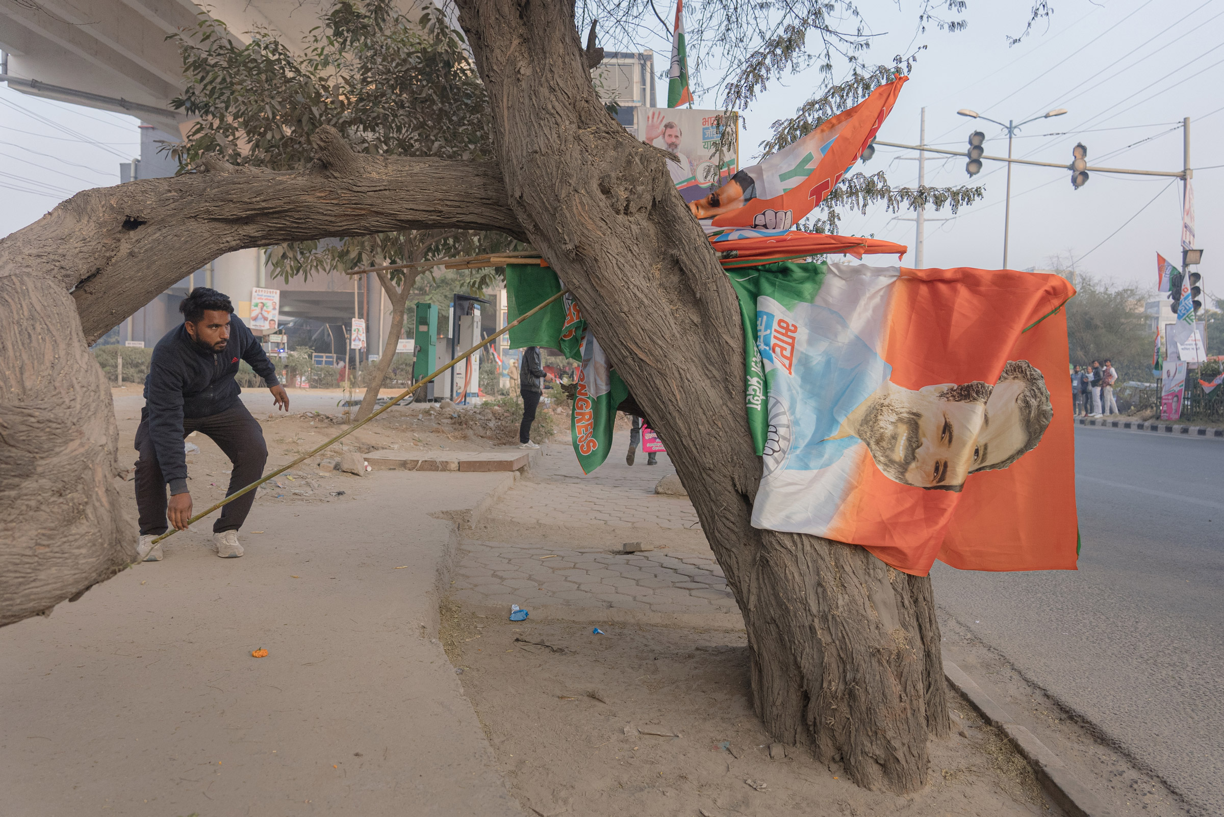 A supporter of the Congress Party gathers flags in New Delhi, India, on Dec. 24, 2022. (Ronny Sen for TIME)