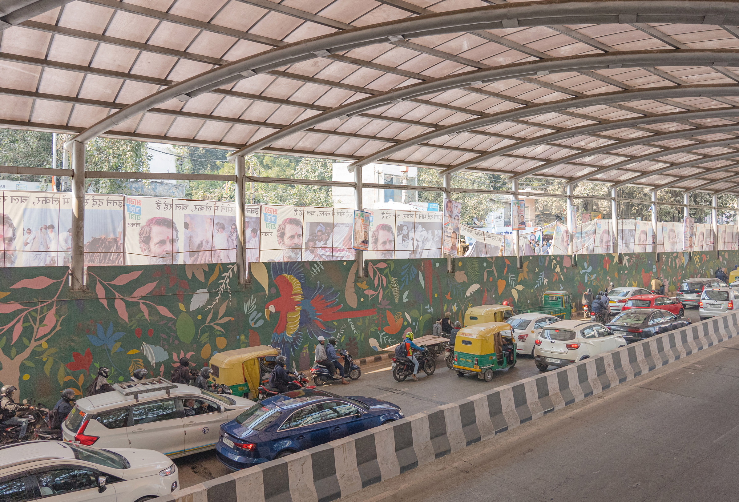 Traffic moves past posters of the Bharat Jodo Yatra, which line the streets of New Delhi, India. (Ronny Sen for TIME)