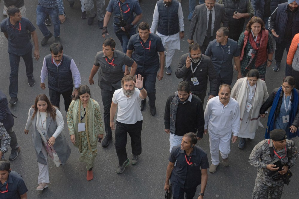 Rahul Gandhi and his companions walk amidst supporters on the Bharat Jodo Yatra, or the Unite India March