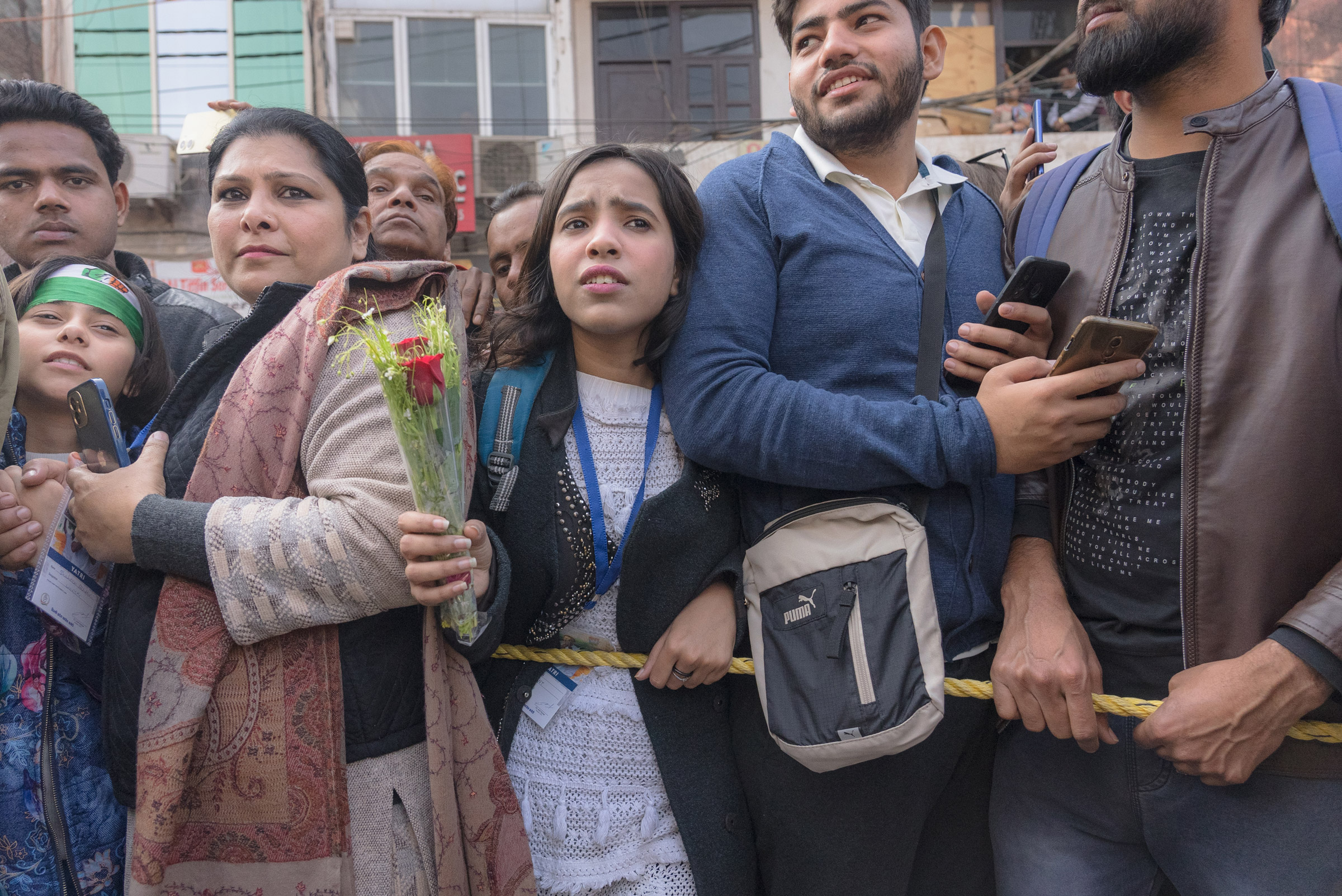 A girl tries to break from the crowd to present a bouquet of flowers to Rahul Gandhi in New Delhi, India