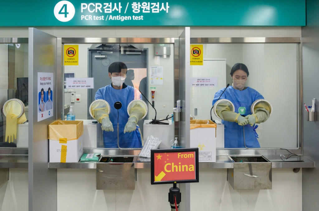 Quarantine officials seen preparing for a PCR test for travelers arriving from China in COVID-19 testing station at Incheon International Airport, west of Seoul, on January 2, 2023. South Korea started requiring COVID-19 testing for arrivals from China at Incheon International Airport, the gateway to South Korea. (Kim Jae-Hwan–SOPA Images/LightRocket/Getty Images)