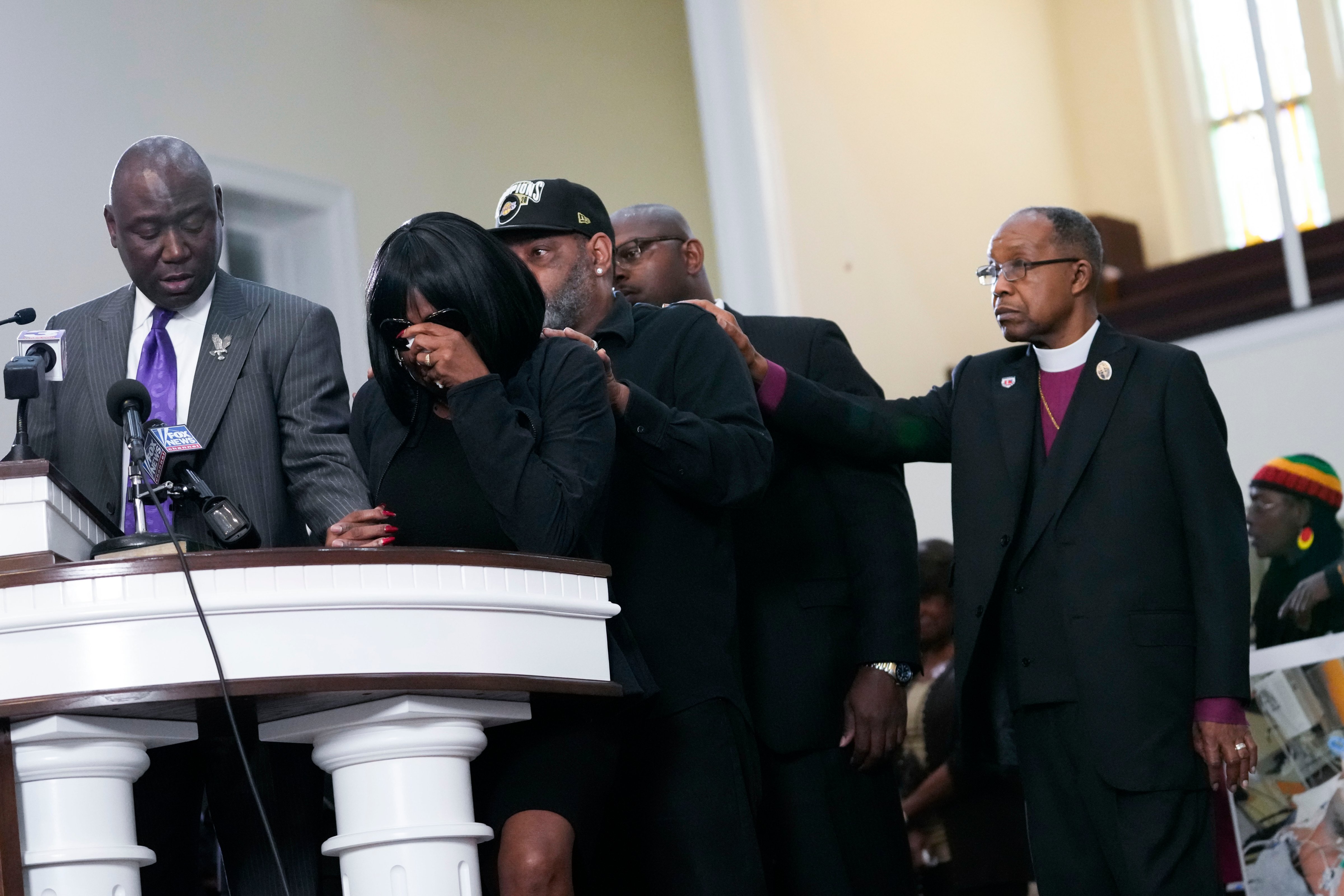 RowVaughn Wells, second from left, mother of Tyre Nichols, who died after being beaten by Memphis police officers, cries as she is comforted by Tyre's stepfather Rodney Wells, behind her, at a news conference with civil rights Attorney Ben Crump, left, in Memphis, Tenn., Monday, Jan. 23, 2023. (AP—Copyright 2023 The Associated Press.)