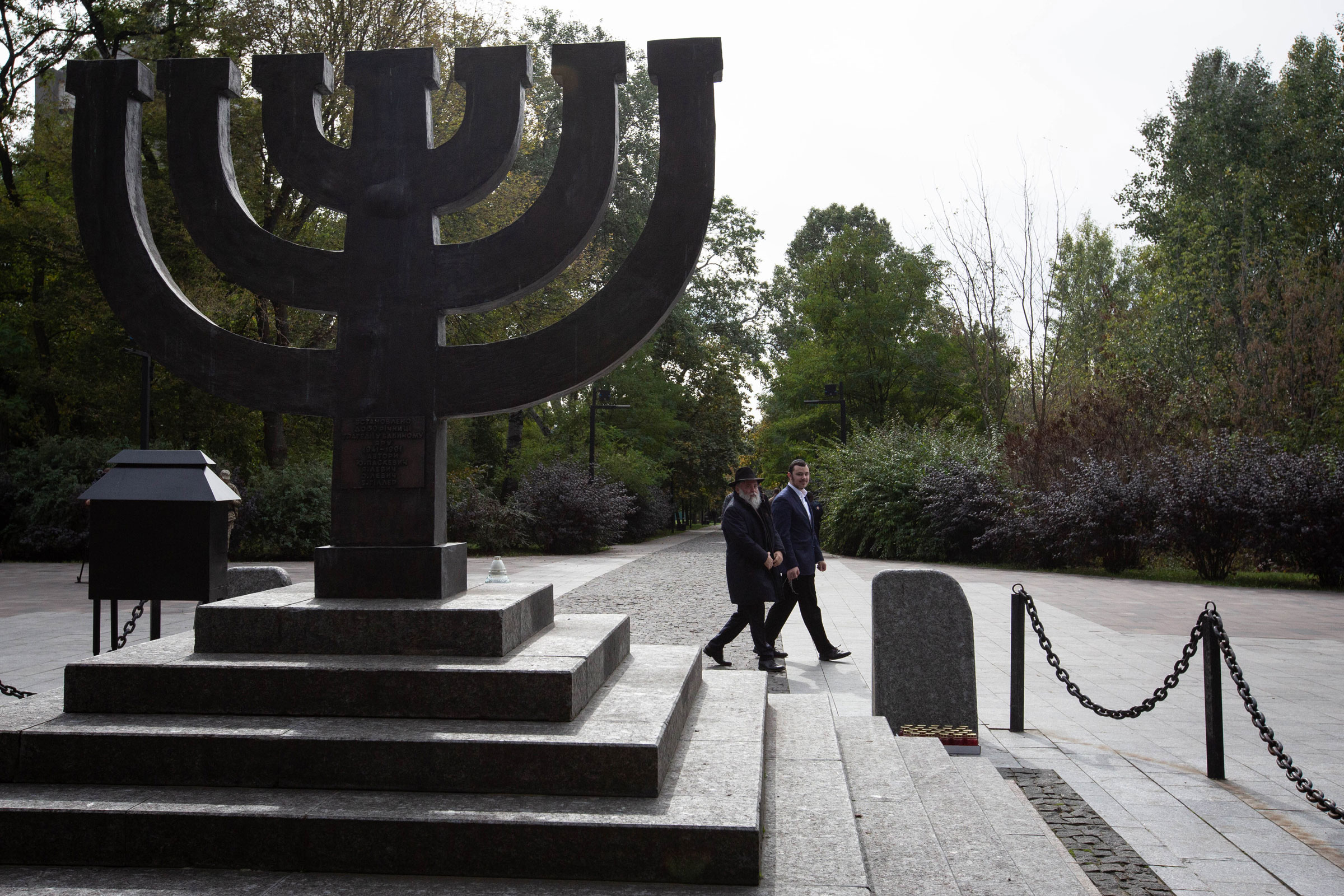 A rabbi walks past a monument commemorating the victims of Babyn Yar, one of the biggest single massacres of Jews during the Holocaust, in Kyiv on Sept. 29, 2022. (Oleksii Chumachenko—SOPA Images/LightRocket/Getty Images)