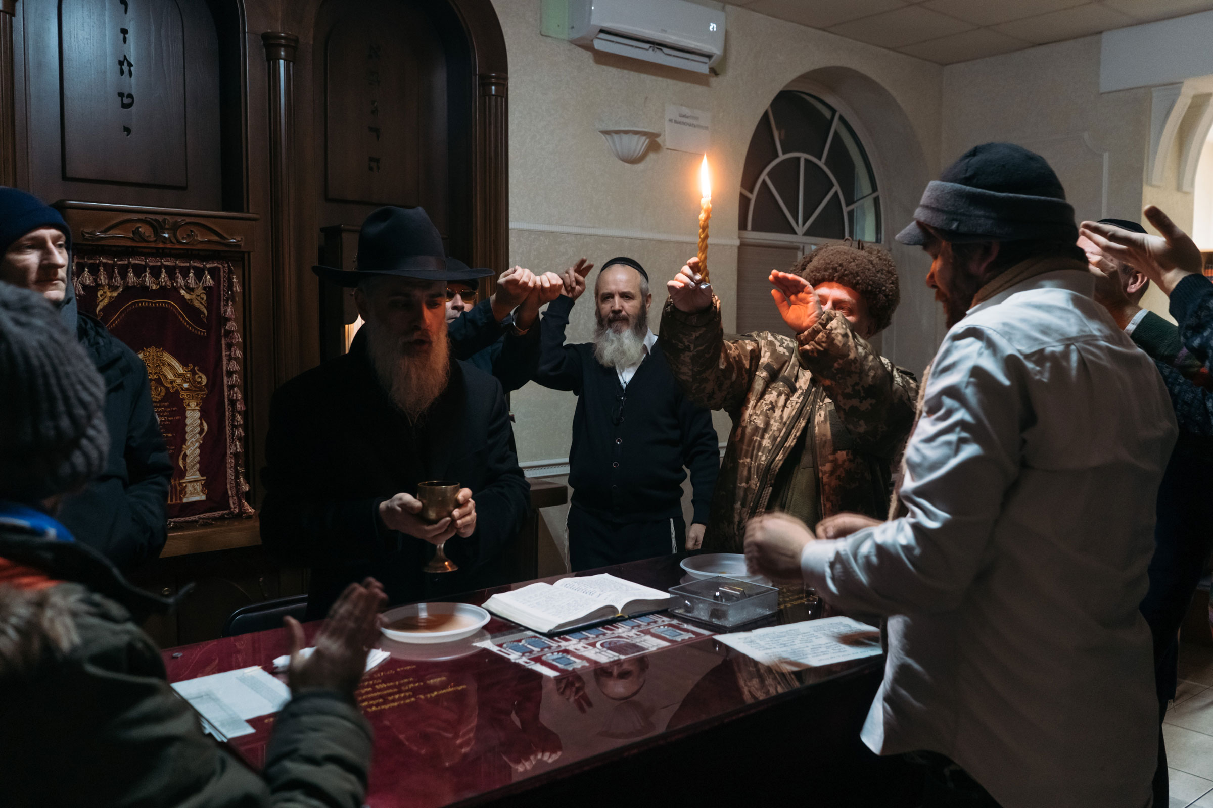 Rabbi David Goldich blesses the wine during sabbath prayer at the Great Choral Synagogue in Kyiv on Dec. 10, 2022. (Anastasia Vlasova—The Washington Post/Getty Images)
