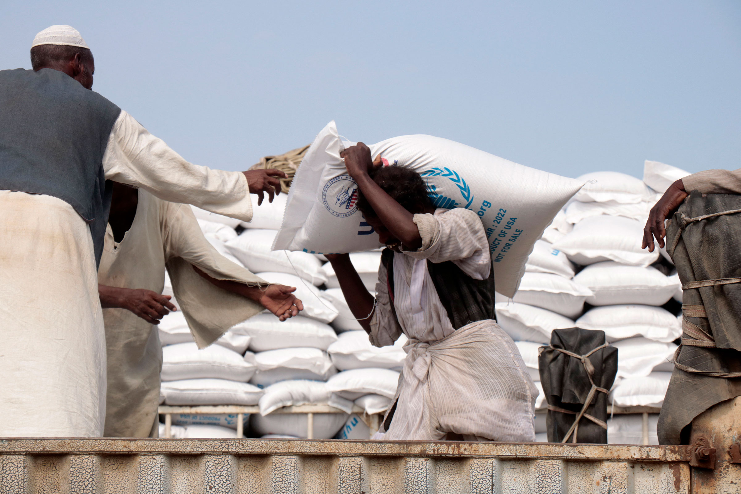 Sacs of corn are loaded onto trucks in the Sudanese Red Sea city of Port Sudan, as part of the US support for Sudan in the field of humanitarian aid, on Nov. 20, 2022. (AFP/Getty Images)