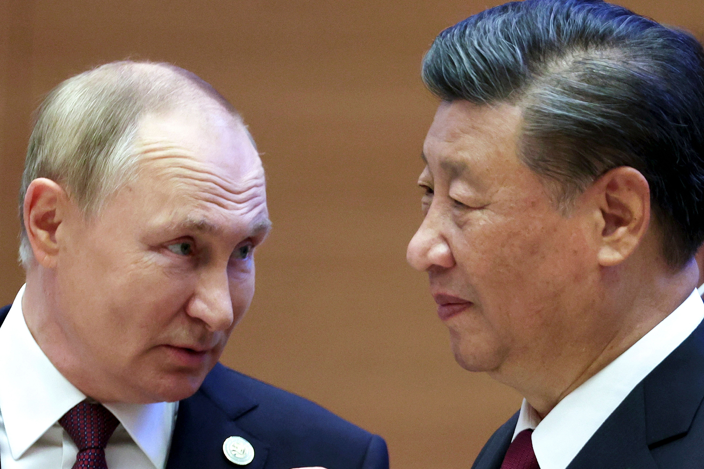 Russian President Vladimir Putin, left, speaks to Chinese President Xi Jinping during the Shanghai Cooperation Organization (SCO) summit in Samarkand, Uzbekistan on Sept. 16, 2022. (Sergei Bobylev—AP/Shutterstock)