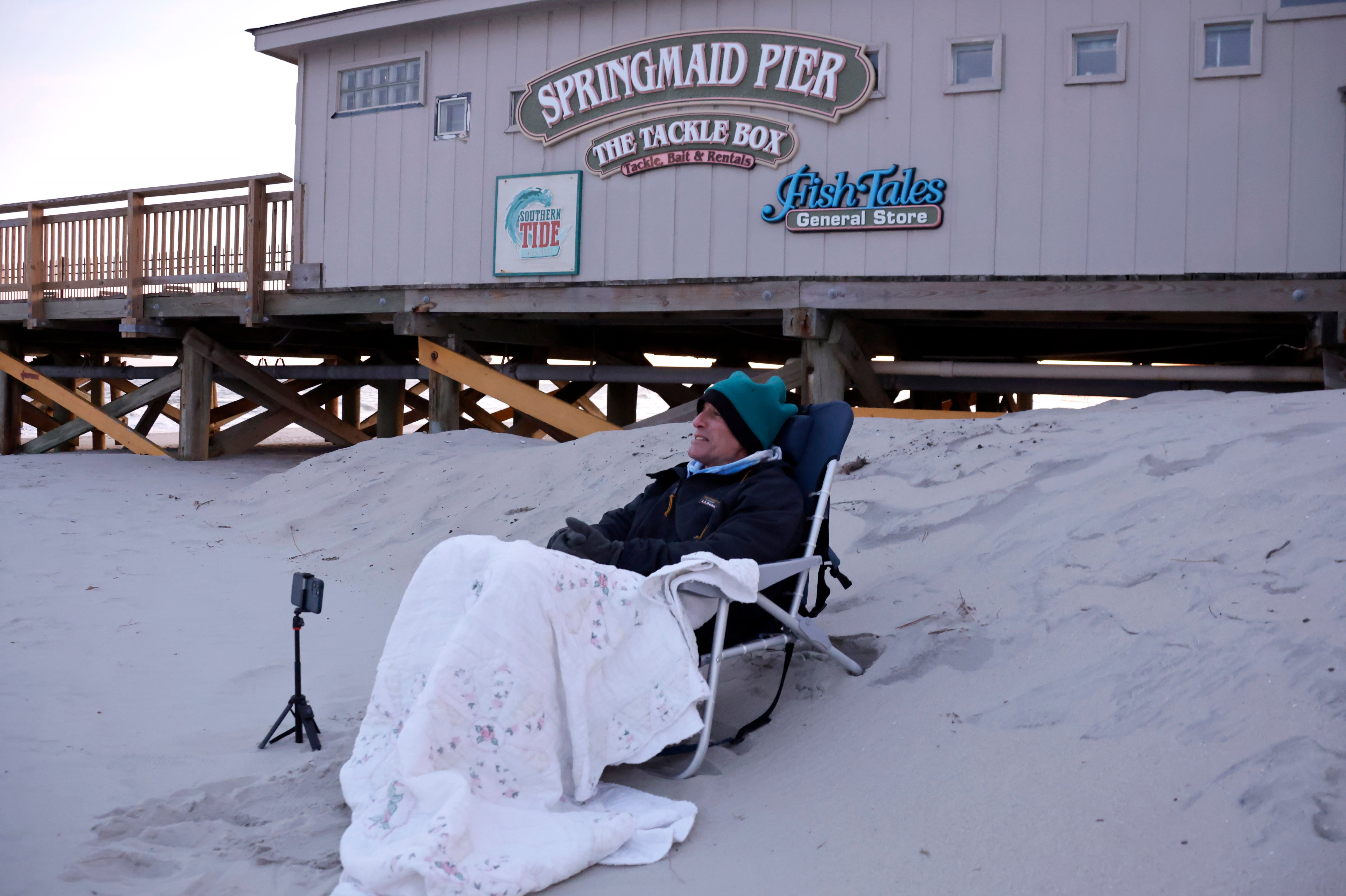 Local Peter Flynn sits near the Springmaid Pier in Myrtle Beach, S.C., Saturday, Feb. 4, 2023. He witnessed the Chinese balloon getting shot down in the area earlier in the day. (Chris Seward—AP Photo)