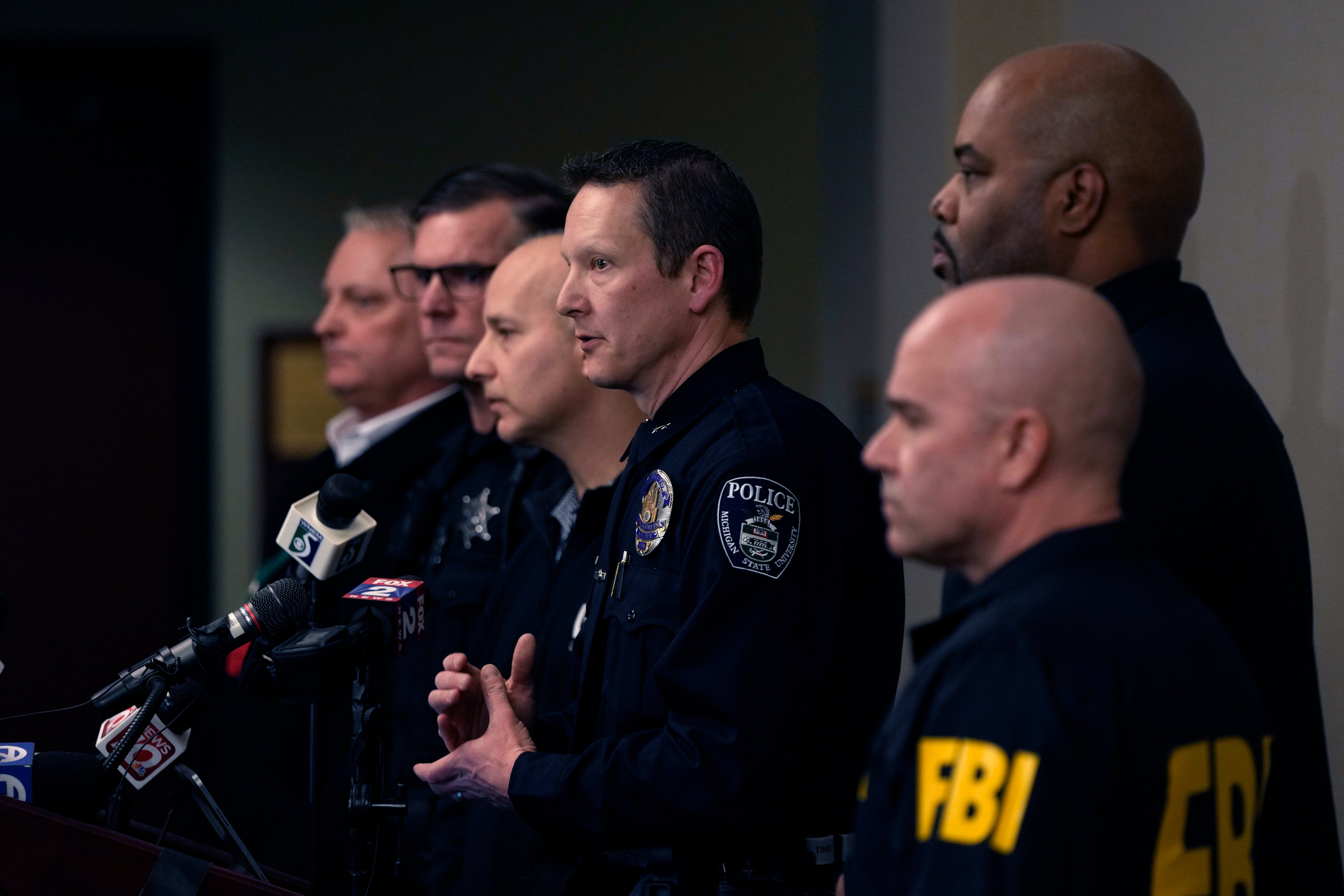 Michigan State University Interim Deputy Police Chief Chris Rozman, center, is joined by other local and federal law enforcement officials while addressing the media, Tuesday, Feb. 14, 2023. (Carlos Osorio—AP)