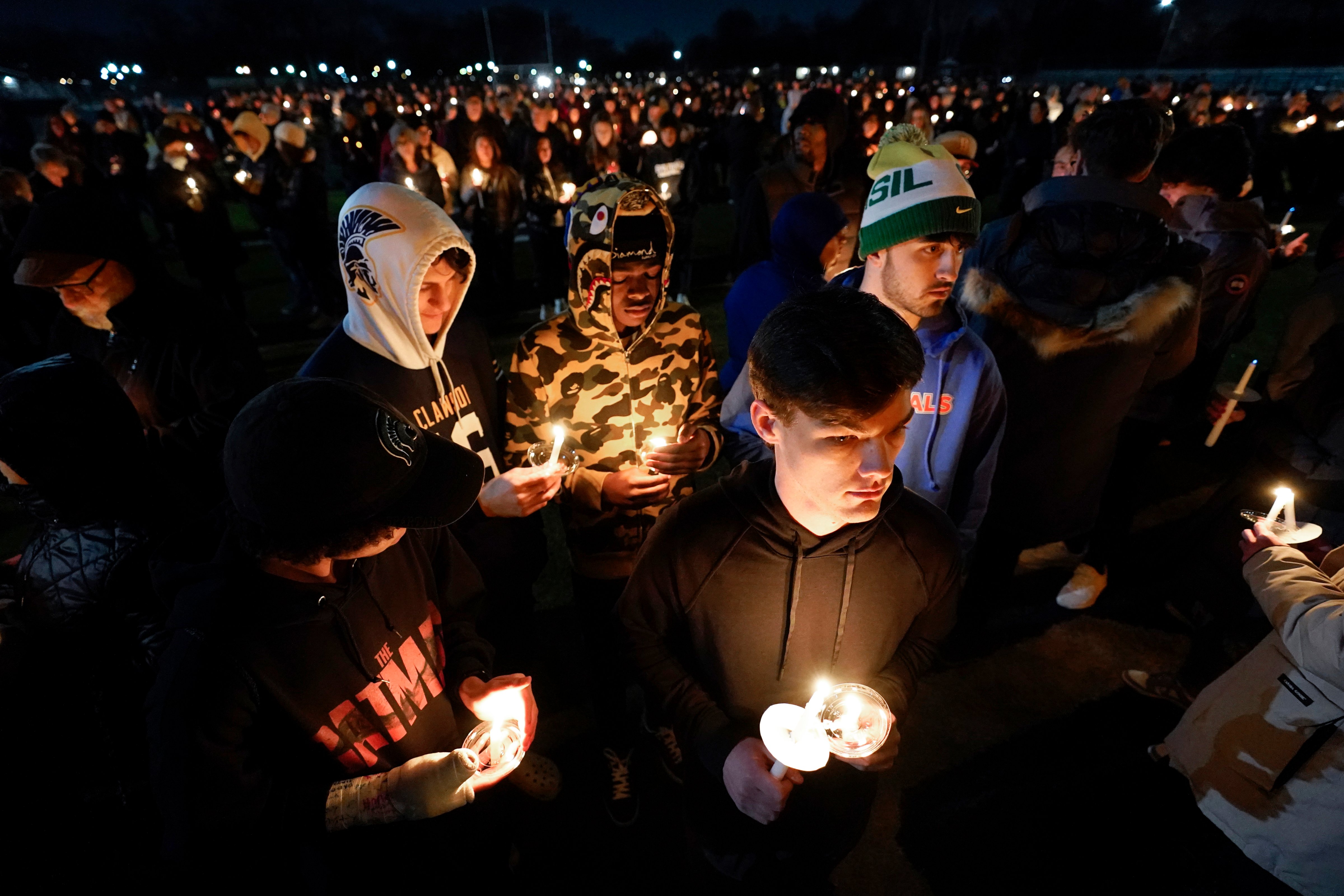 Mourners attend a candlelight vigil for Alexandria Verner, one of the students killed at Michigan State University Monday night, at Clawson High School football field, Tuesday, Feb. 14, 2023. (Paul Sancya—AP)
