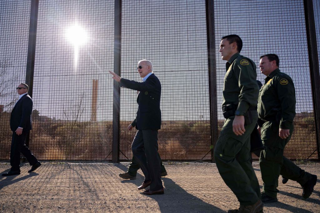 Jim Watson—AFP/Getty Images (U.S. President Joe Biden walks along the U.S.-Mexico border fence in El Paso, Texas, on Jan. 8, 2023 for the first time since taking office. This entry point is at the center of debates over illegal immigration and smuggling.)